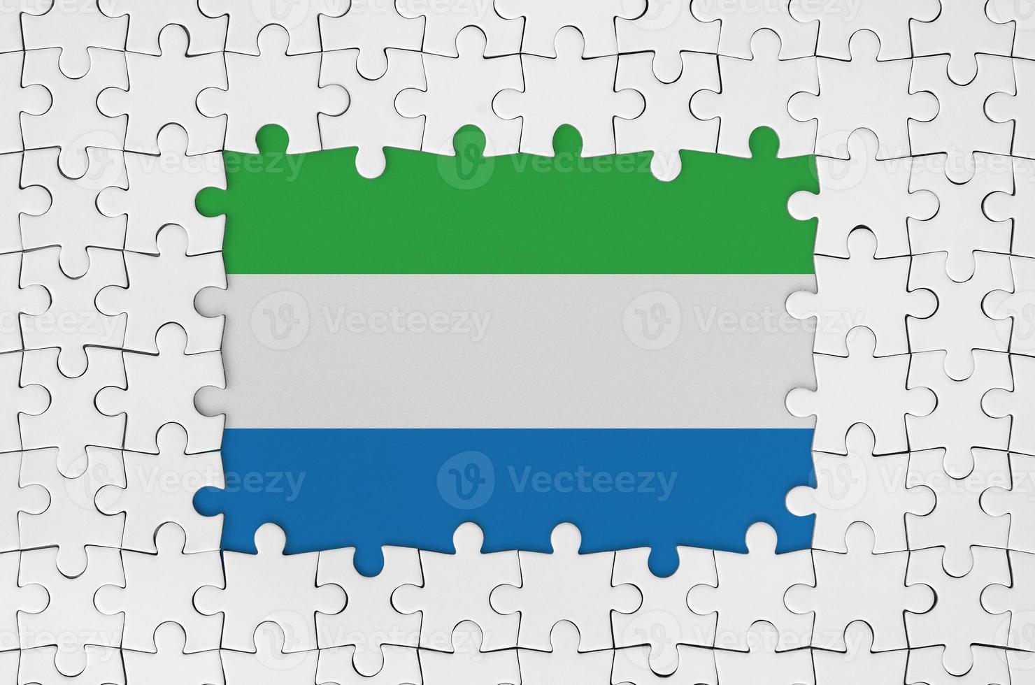 Sierra Leone flag in frame of white puzzle pieces with missing central part photo