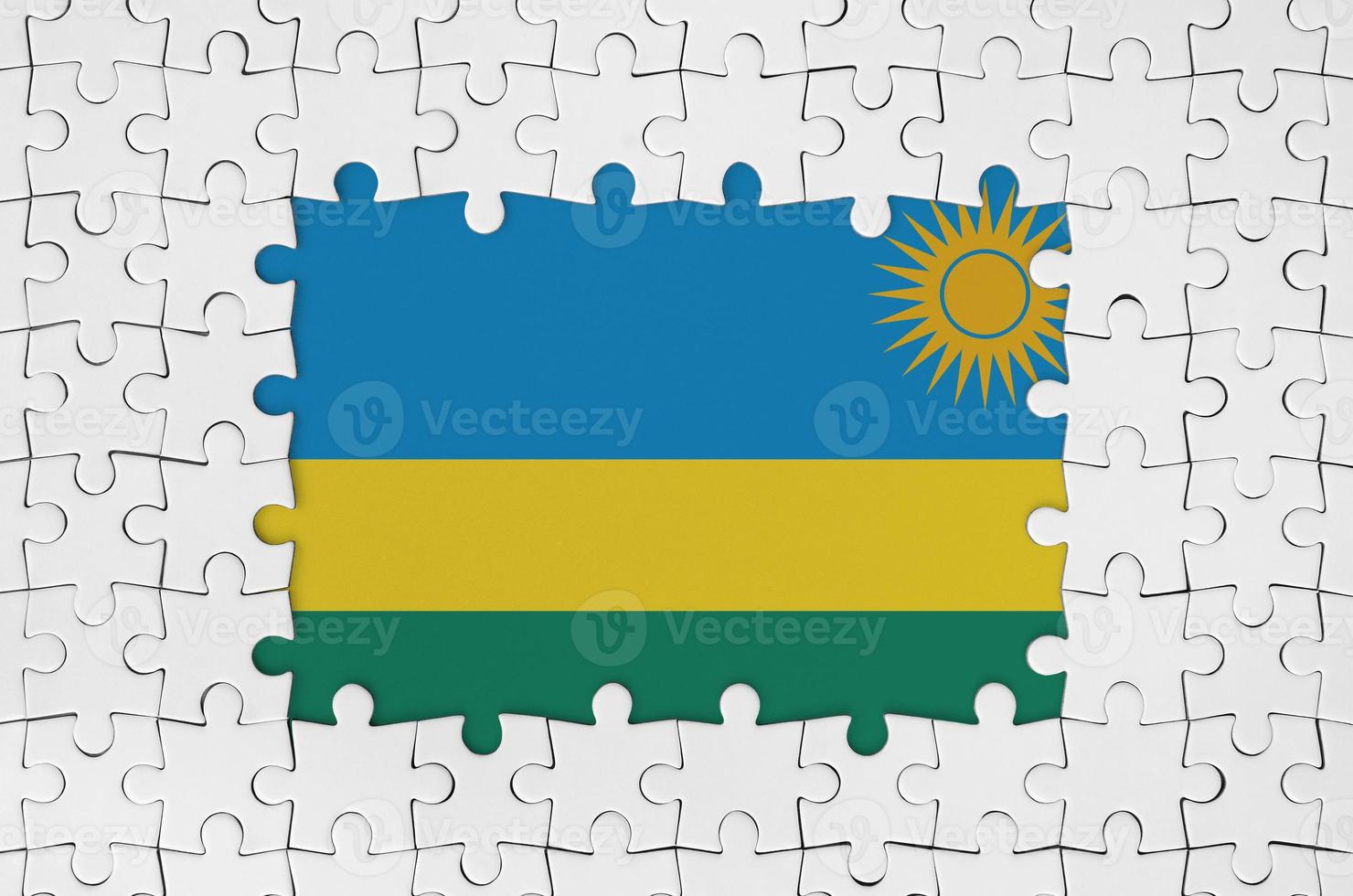 Rwanda flag in frame of white puzzle pieces with missing central part photo