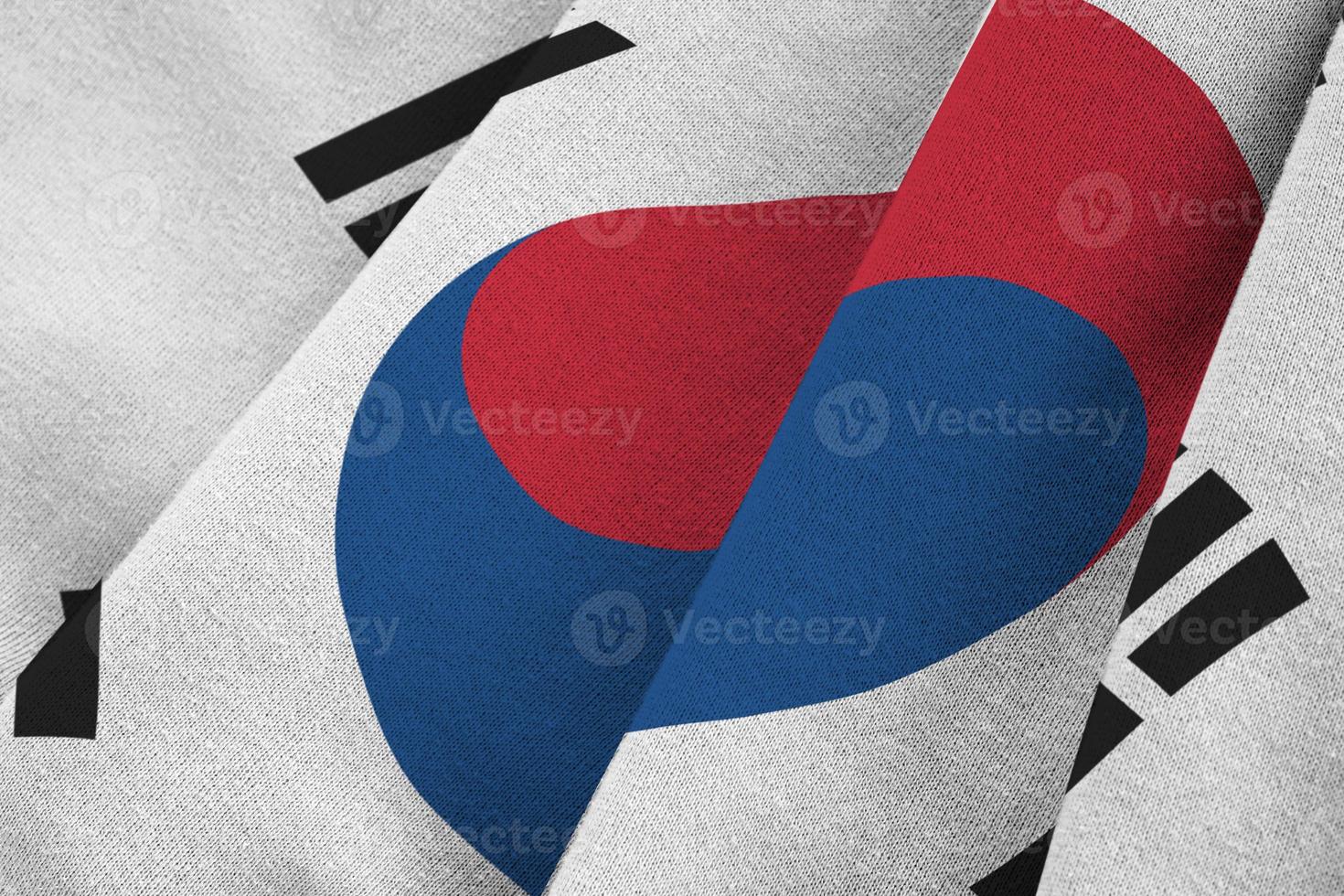 South Korea flag with big folds waving close up under the studio light indoors. The official symbols and colors in banner photo