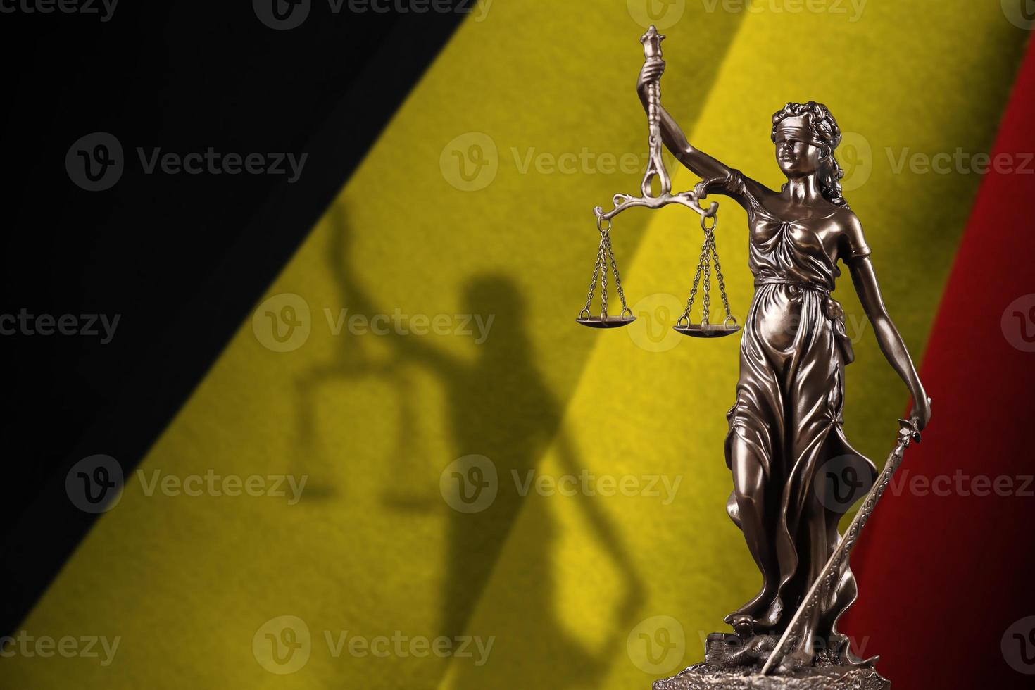 Belgium flag with statue of lady justice and judicial scales in dark room. Concept of judgement and punishment photo