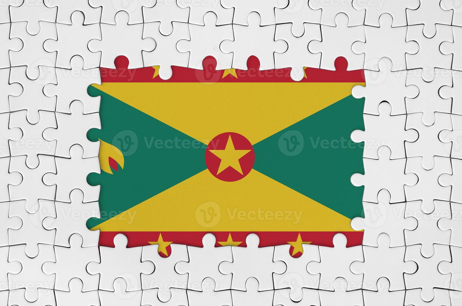 Grenada flag in frame of white puzzle pieces with missing central part photo