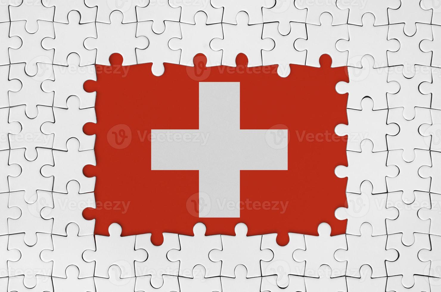 Switzerland flag in frame of white puzzle pieces with missing central part photo