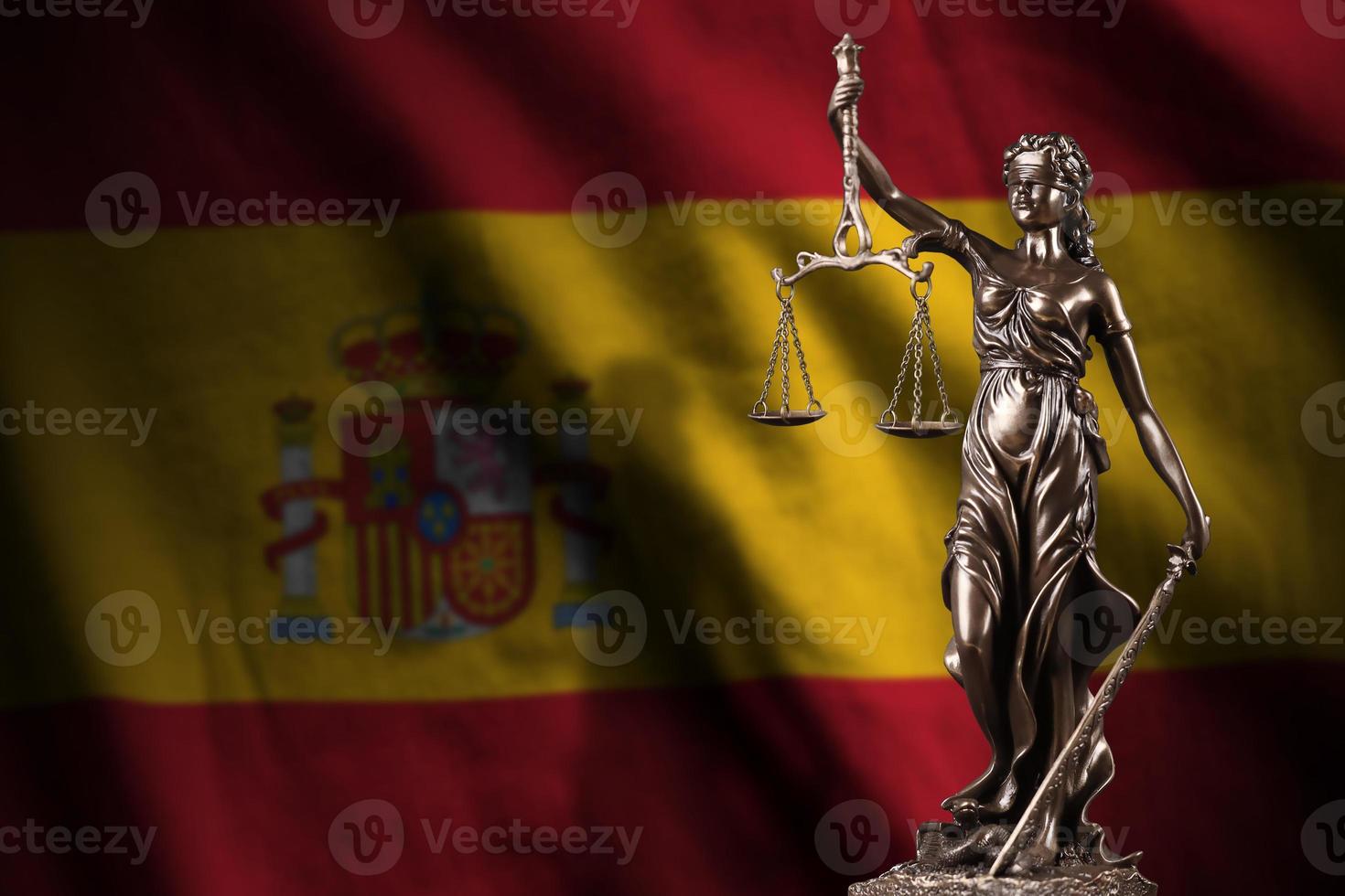 España bandera con estatua de dama justicia y judicial escamas en oscuro habitación. concepto de juicio y castigo foto