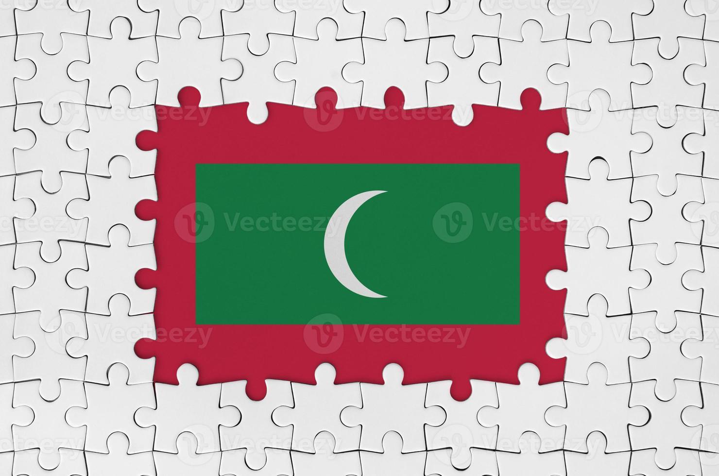 Maldives flag in frame of white puzzle pieces with missing central part photo
