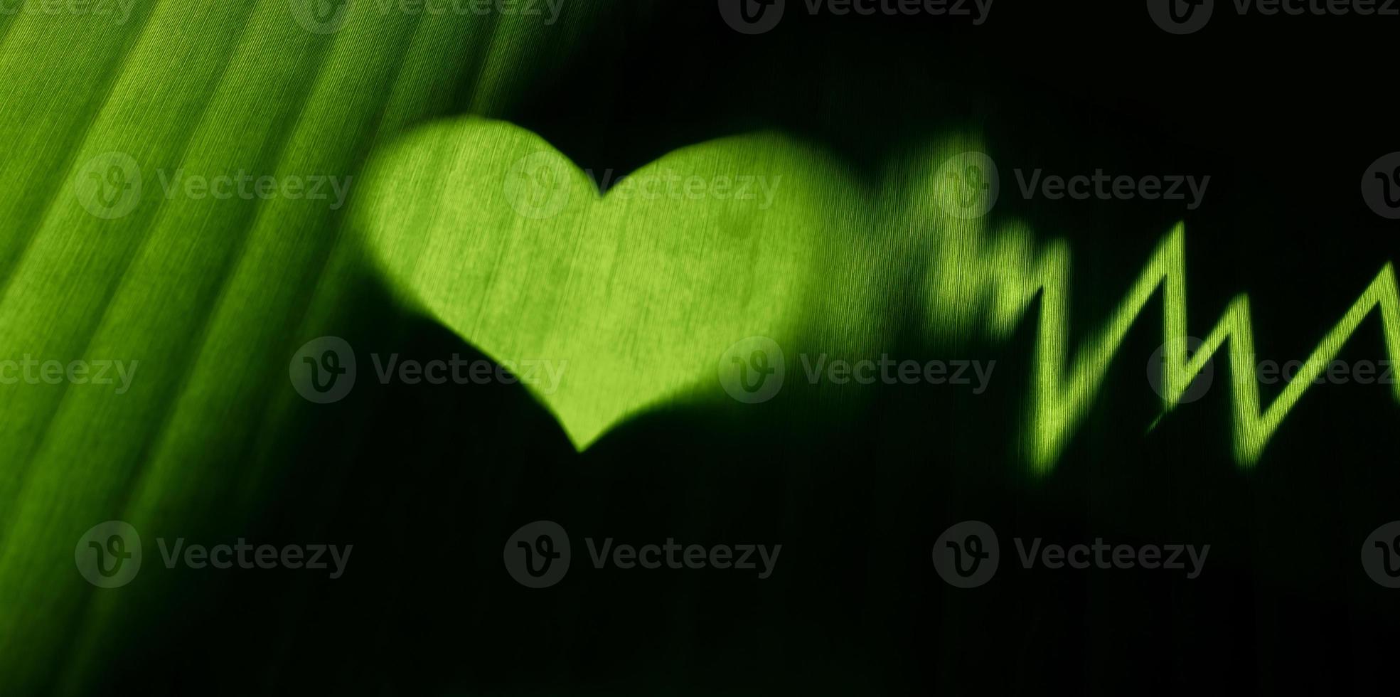 Conceptual Photo. World Environment Day. Global Health Awareness. Green Leaf with Backlit technic as Heart Shape and Beat Rate. Environmental to Love, Care and Sustainable Resources photo