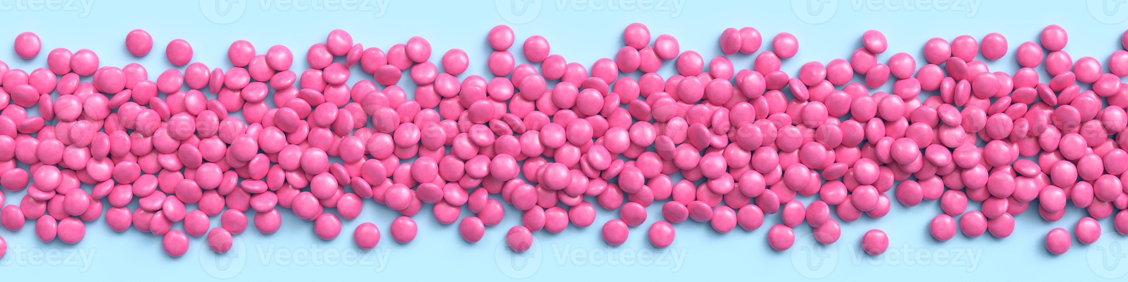 Wide border of pink coated chocolate candies on blue pastel background. 3d rendering photo