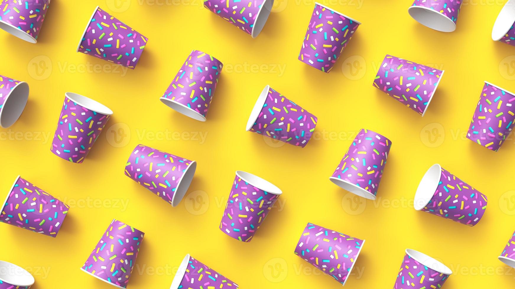 Paper cups with colorful sprinkles pattern diagonally arranged on yellow background photo
