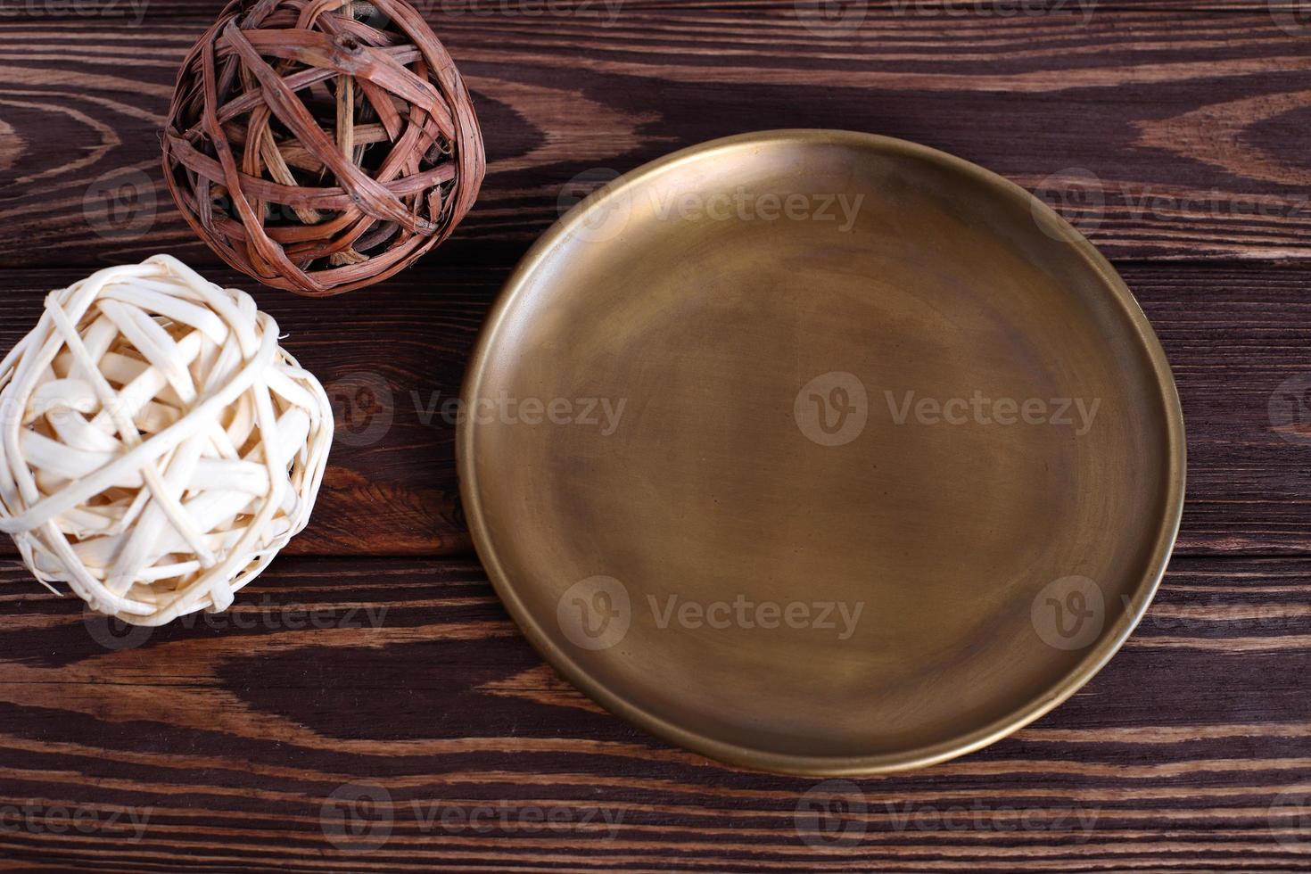 Metal copper plate on wooden table, mock up photo