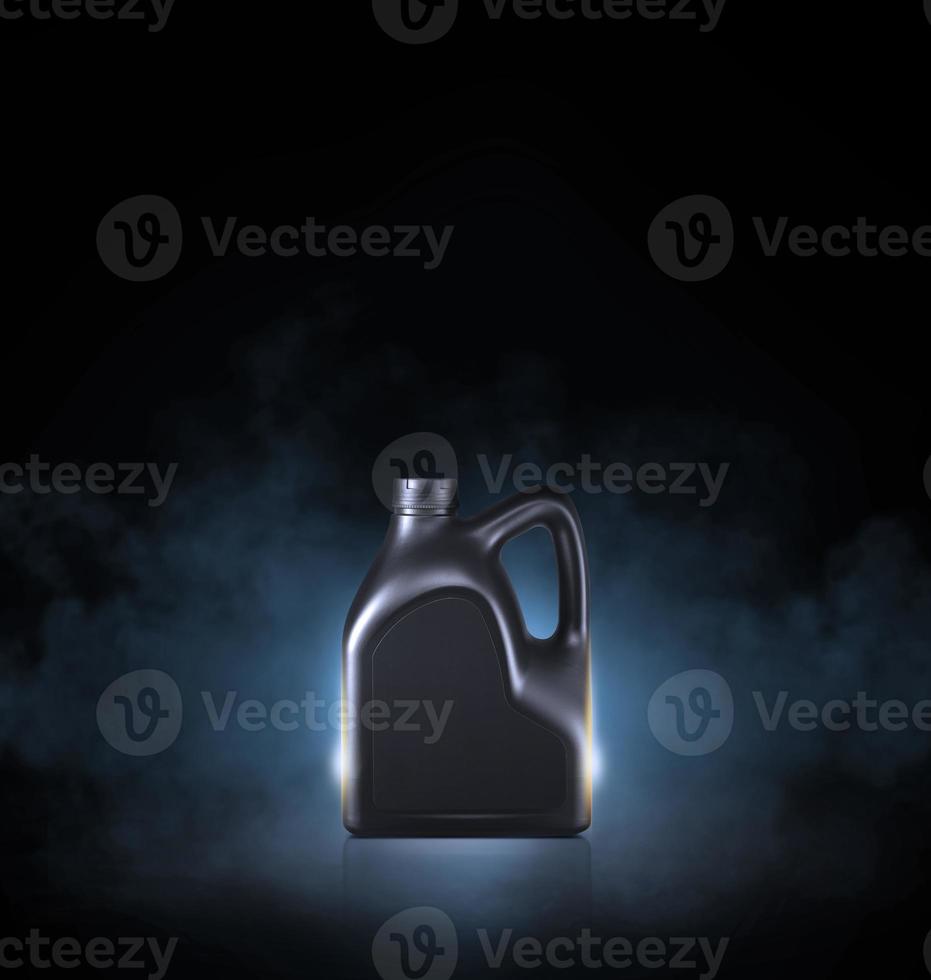 Black bottle of engine oil on black background with smoke photo