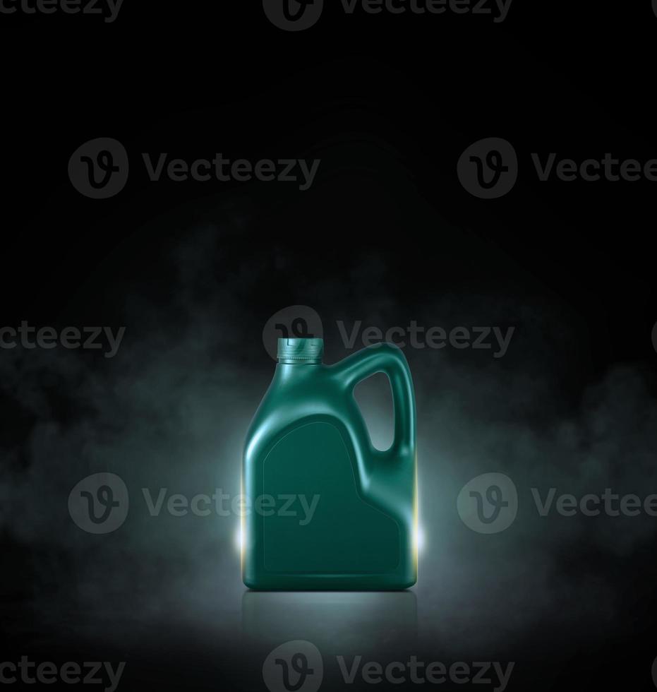 Green bottle of engine oil on black background with smoke photo