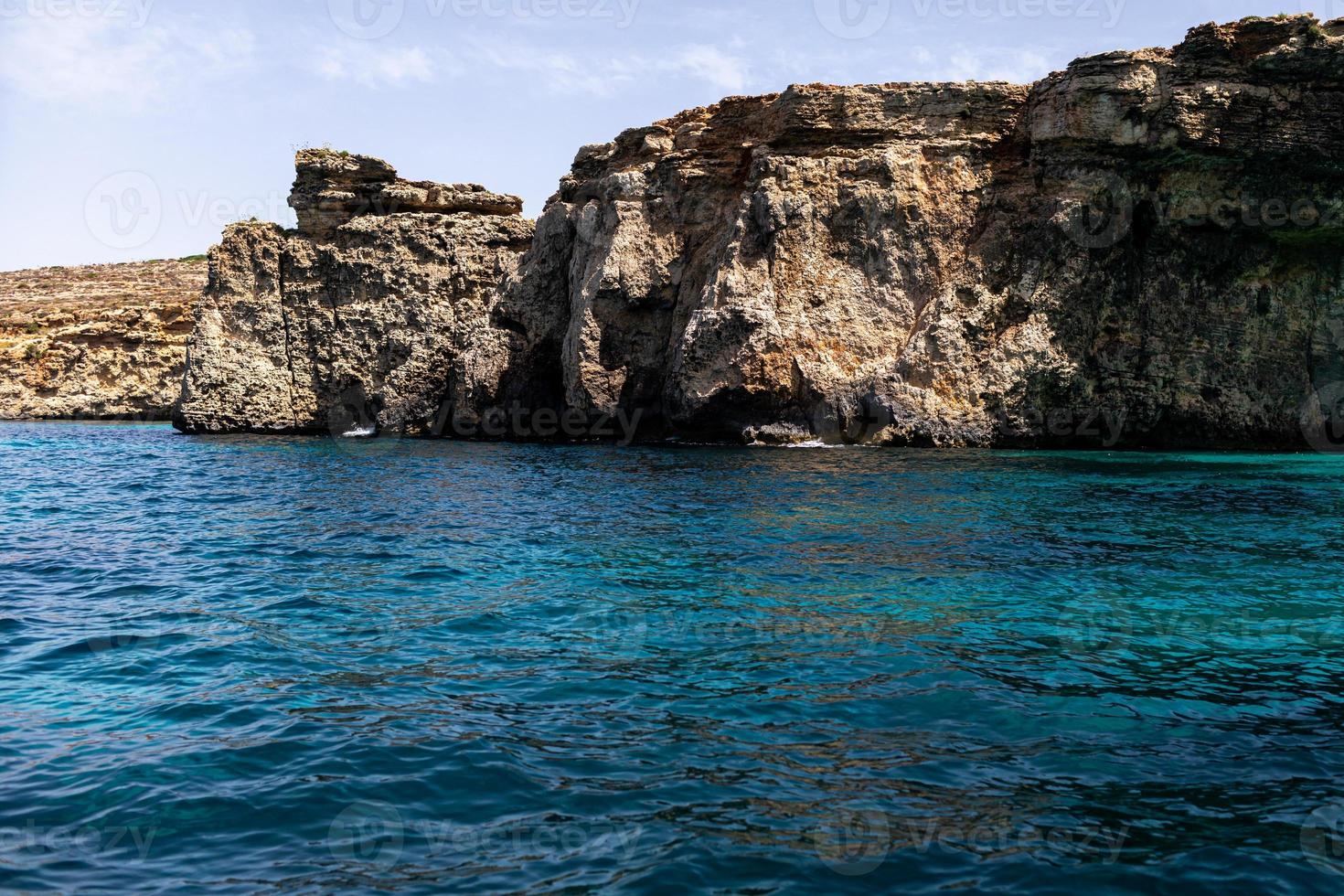 rocks in the sea. Mountain slopes on the background of the sea shore. Seascape with mountain landscape. Photo of a sea landscape.