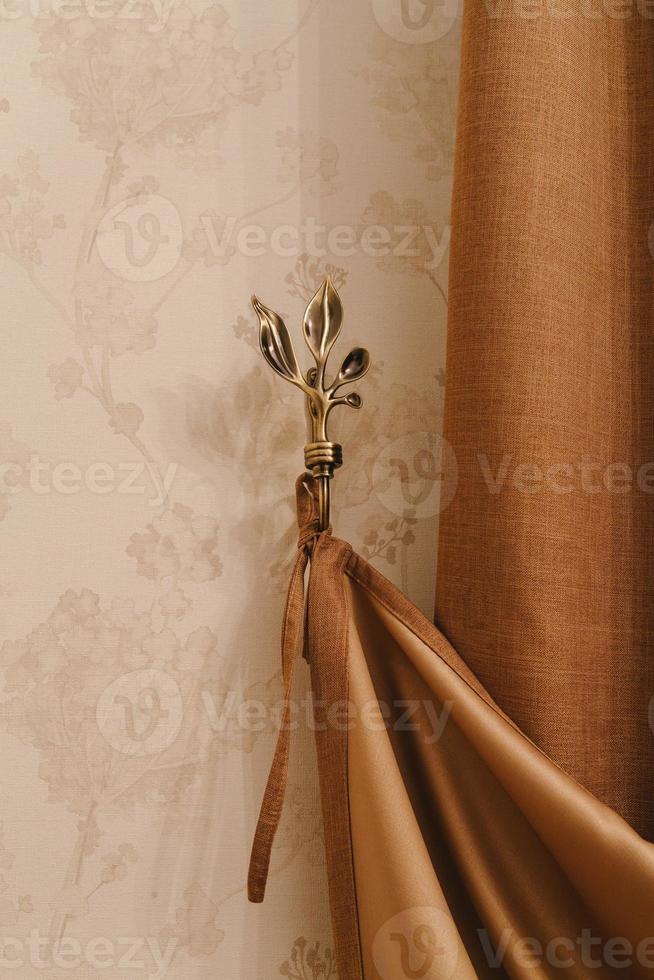 golden holder for room curtains. Fragment photo curtain, interior detail, curtain detail close up