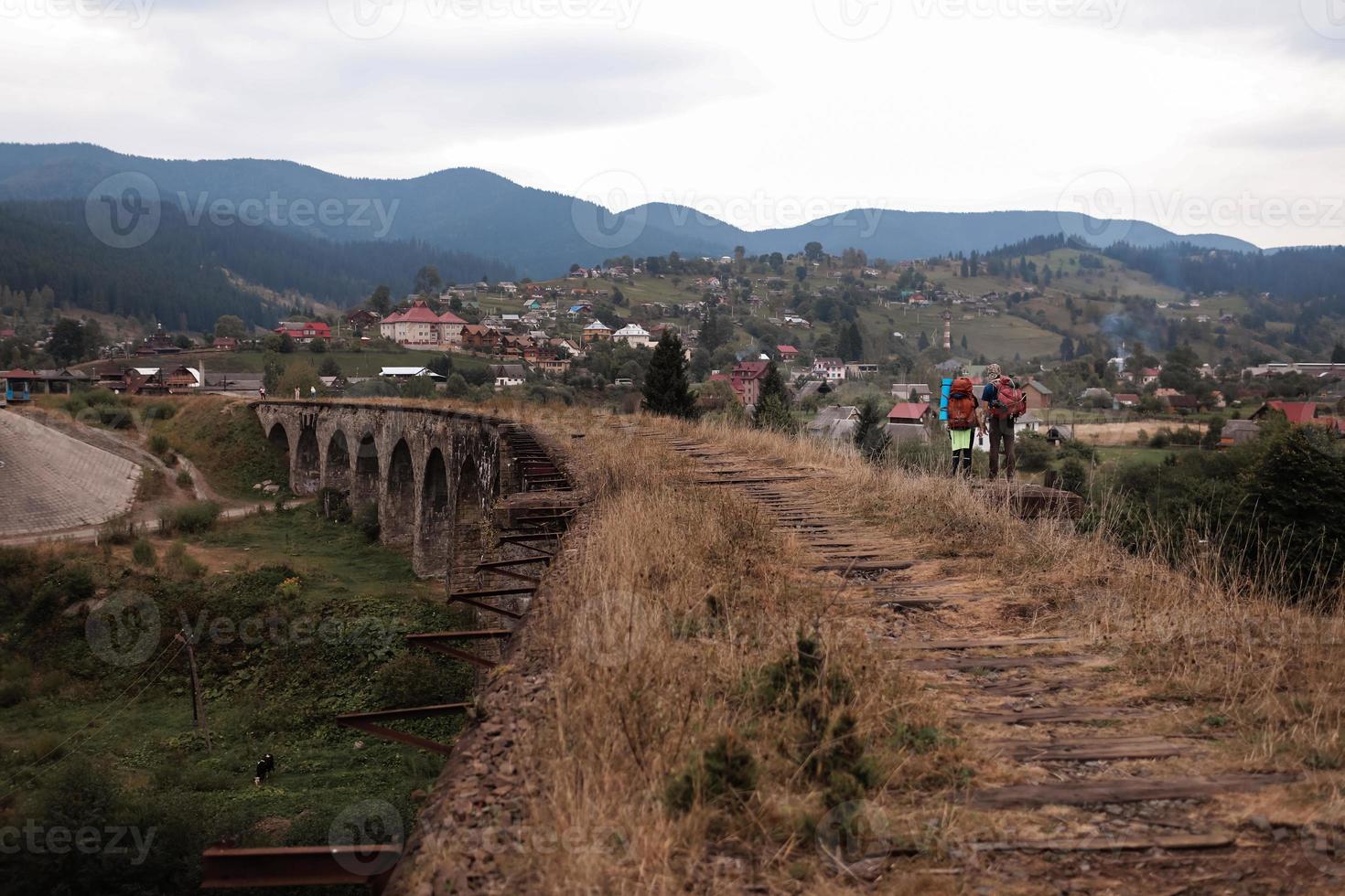 Close view of old railroad tracks with worn ties. Railway viaduct Ukraine, Verkhovyna photo