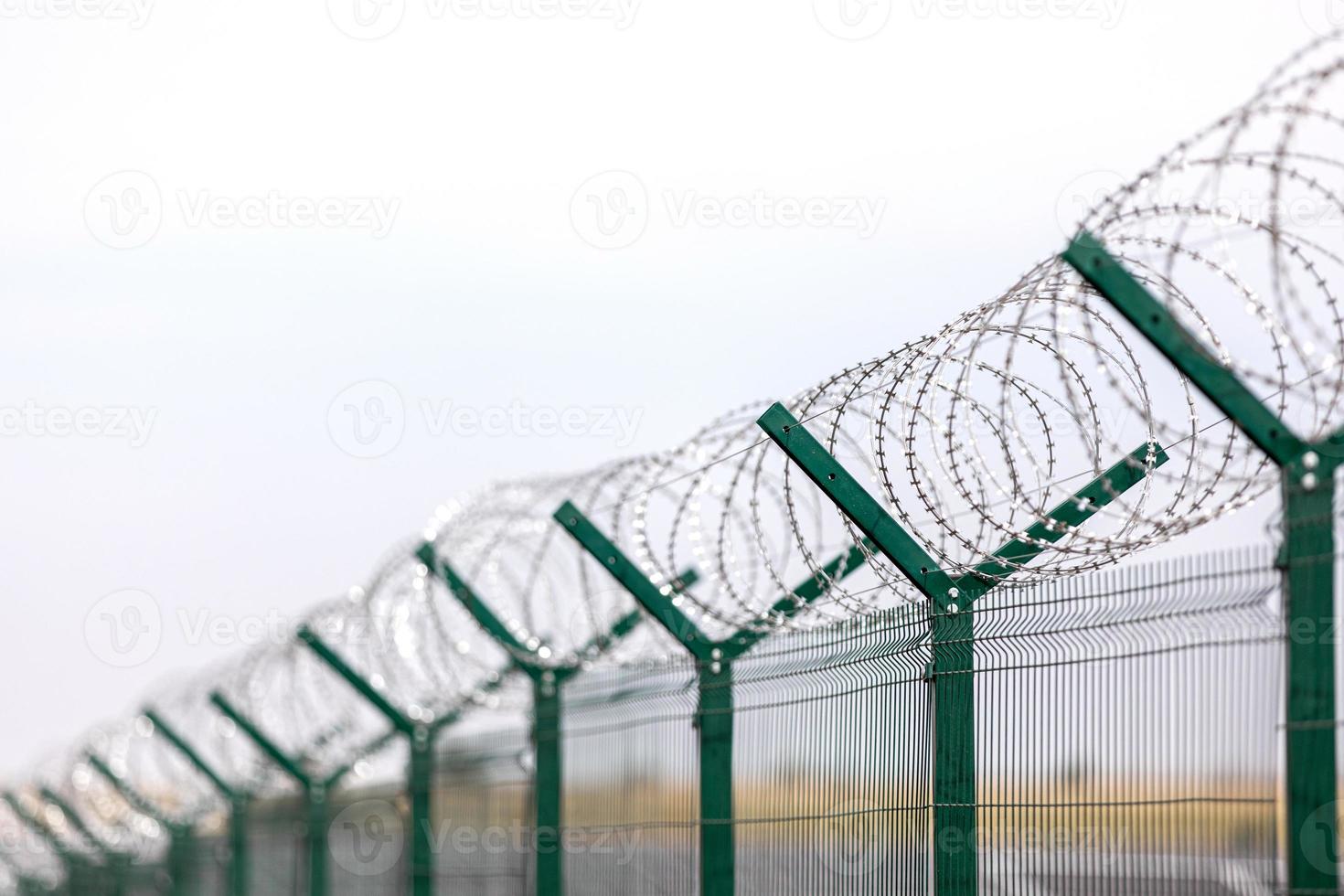 Security with a barbed wire fence. Fencing of sensitive sites with barbed wire. photo