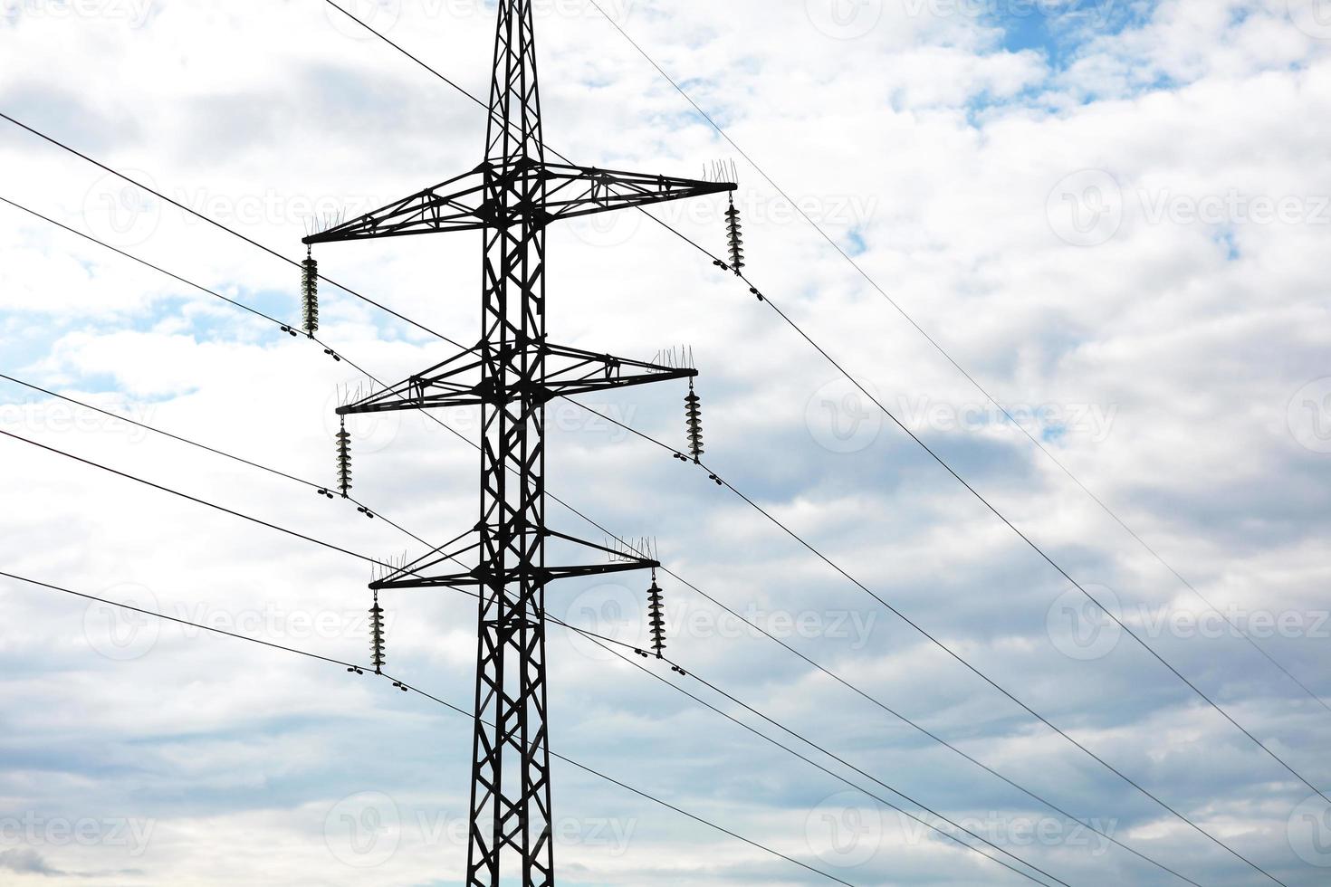 high-voltage power lines on blue sky background. electricity distribution station. Electrical net of poles on a panorama. power tower. photo