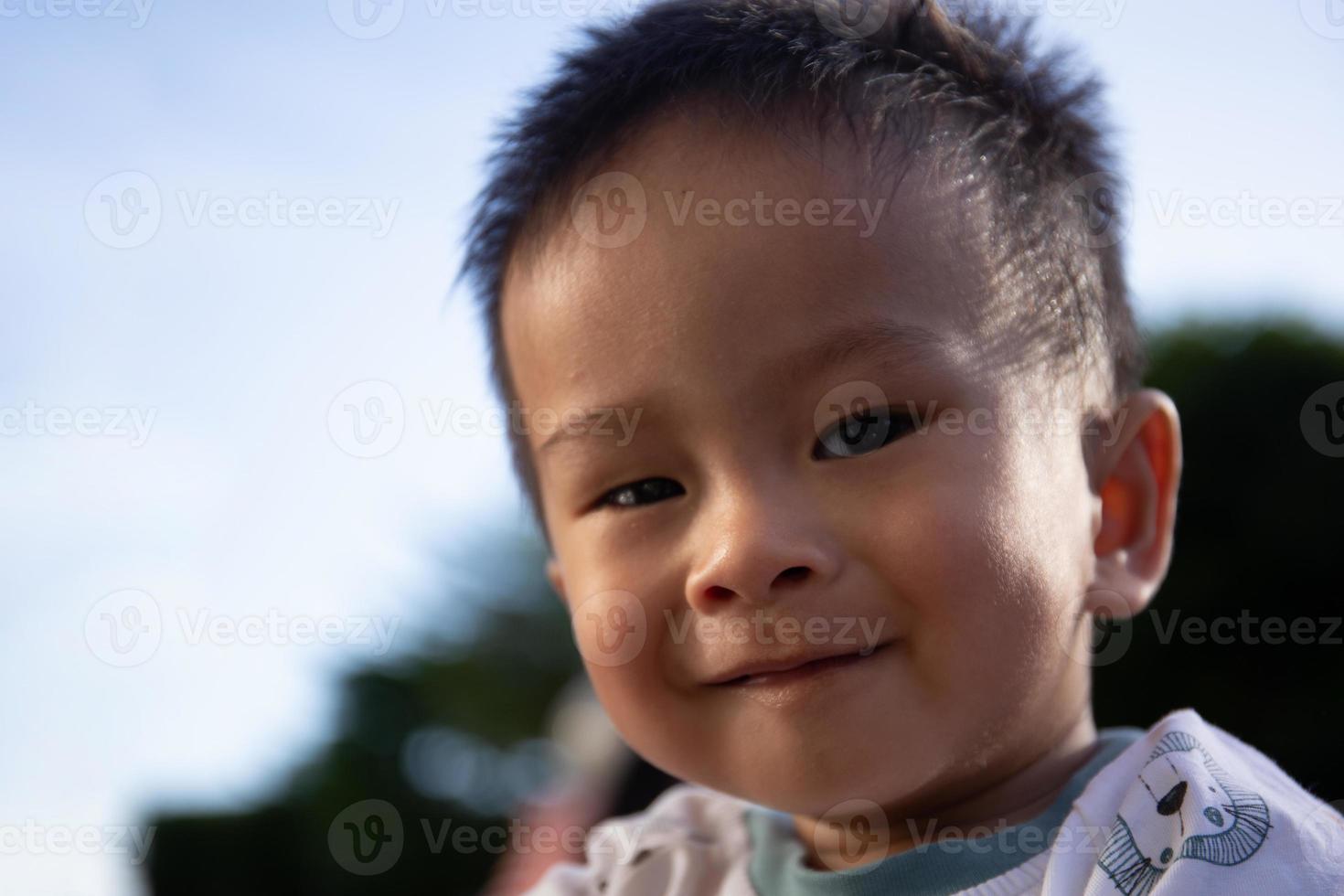 Close up portrait of Asian boy in the sunset photo