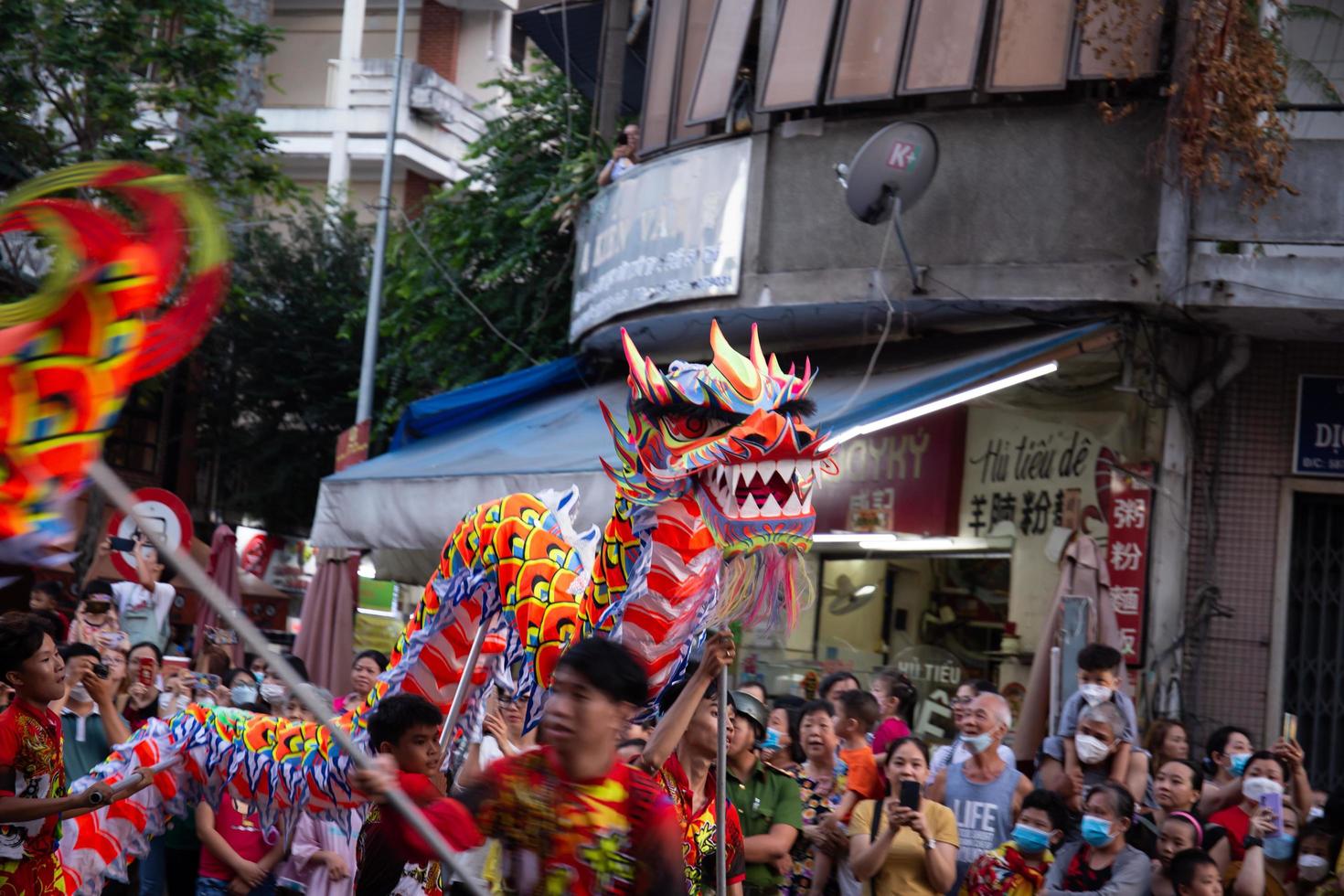 Ho Chi Minh city, Vietnam - 6 Feb 2023 Lunar New Year celebration - The dragon dance, beautiful colorful festive figure. Tet holiday background. Chinese Lunar New Year's Day, Spring Festival. photo