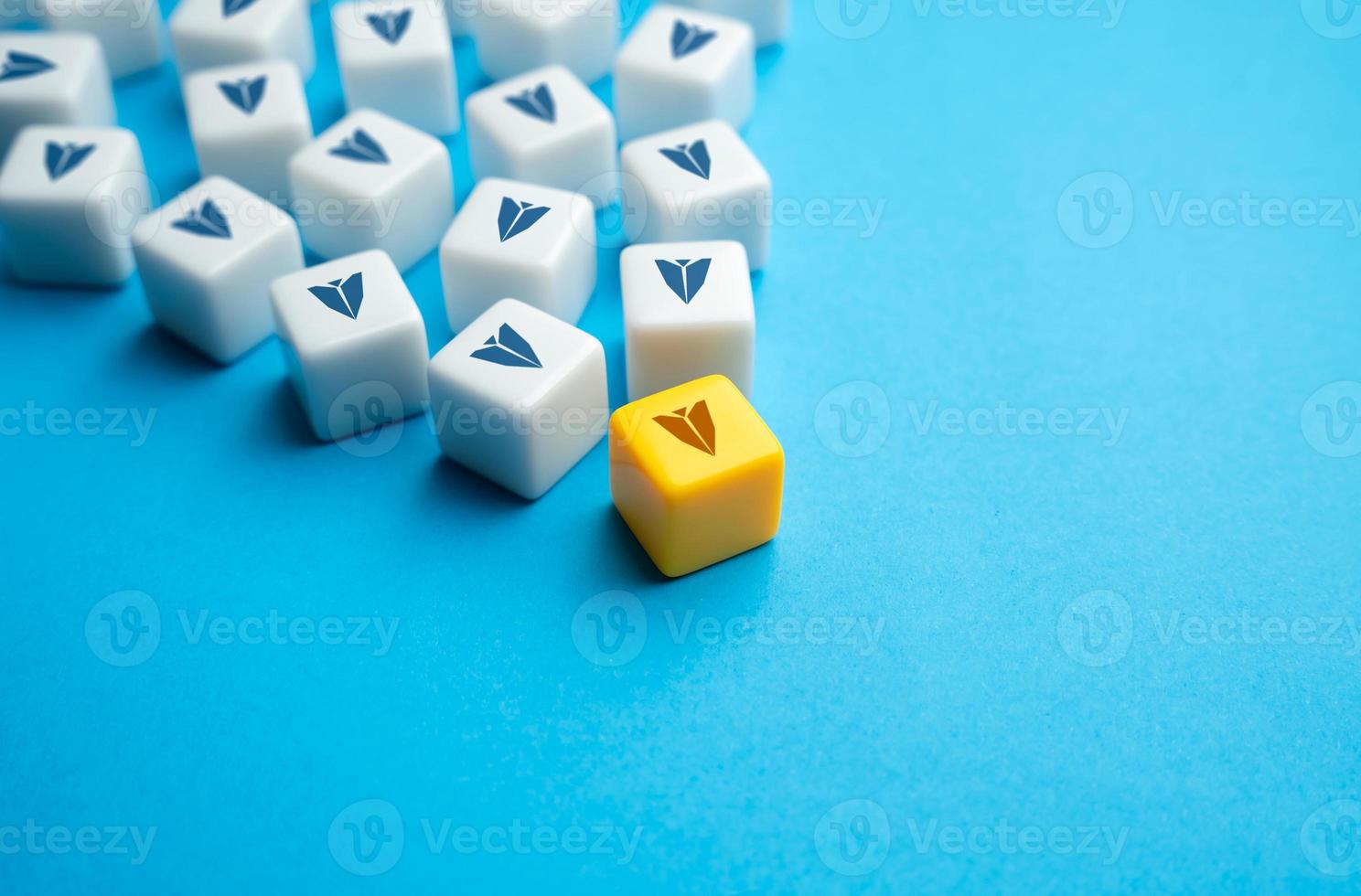 Leader at the head of the movement. Paper airplanes on blocks follow the head. Be in charge. Set course. Self organization and grouping. Following the example. Management of a community or business. photo