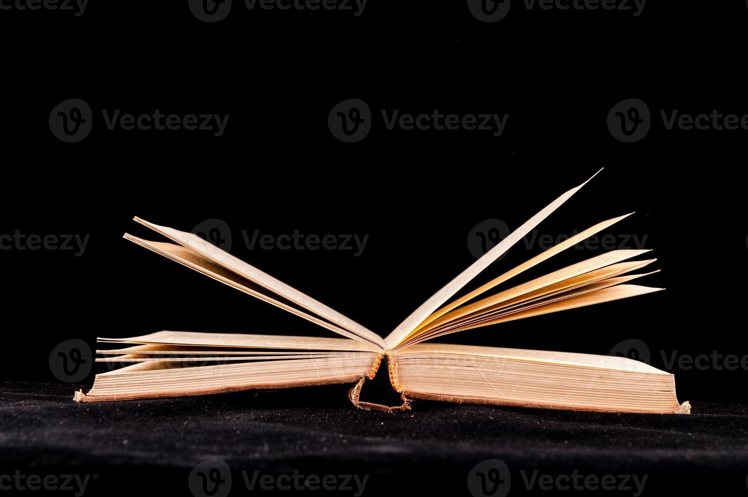 Book on black background photo