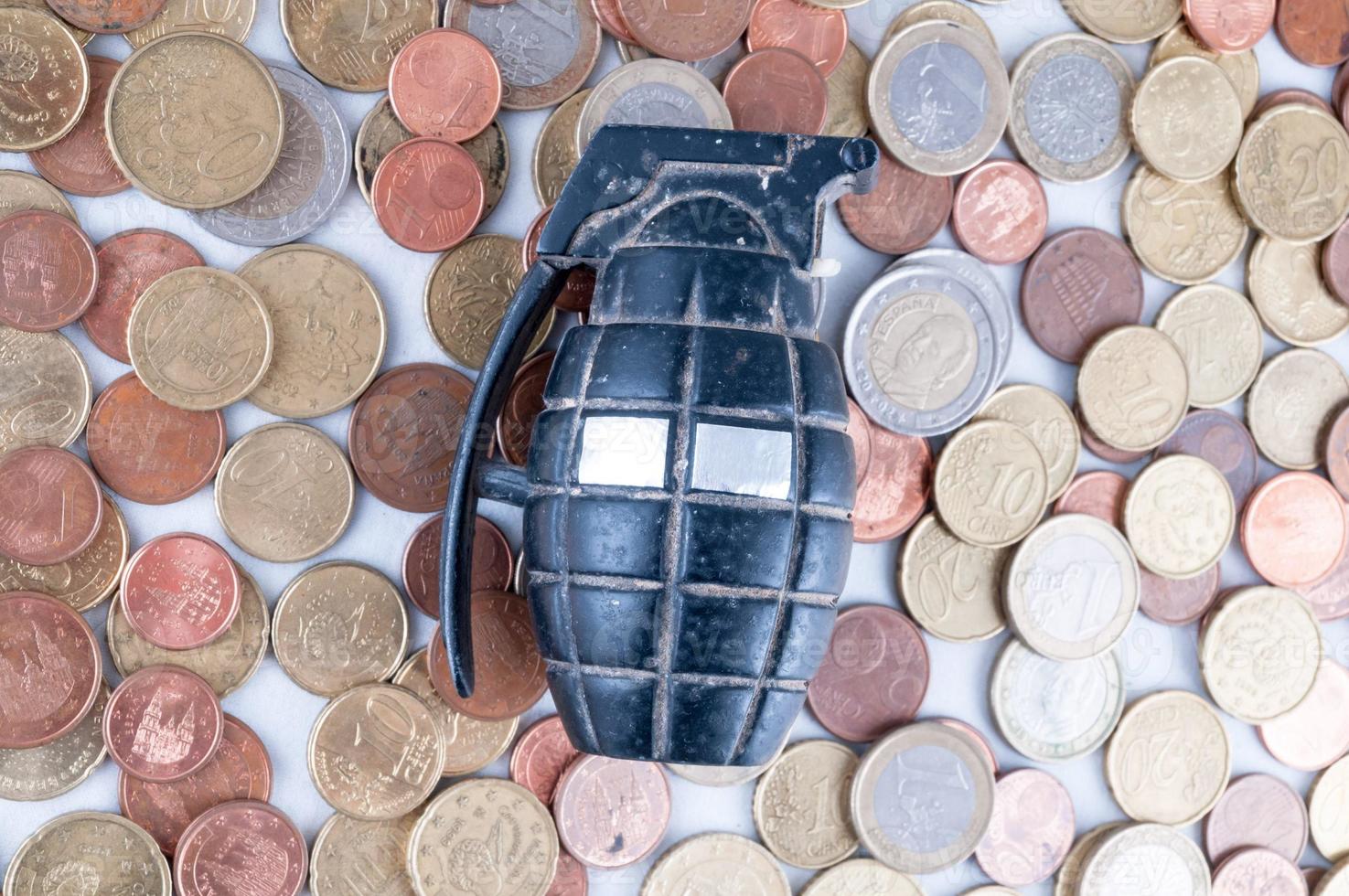 Grenade on pile of coins photo