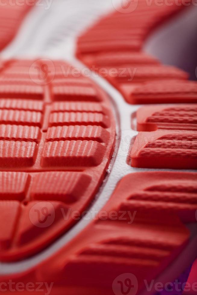 Textured design of the sole of the sport shoe in red Macro. photo
