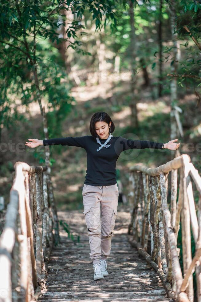 Protrait young woman looking beautiful nature while camping in forest photo