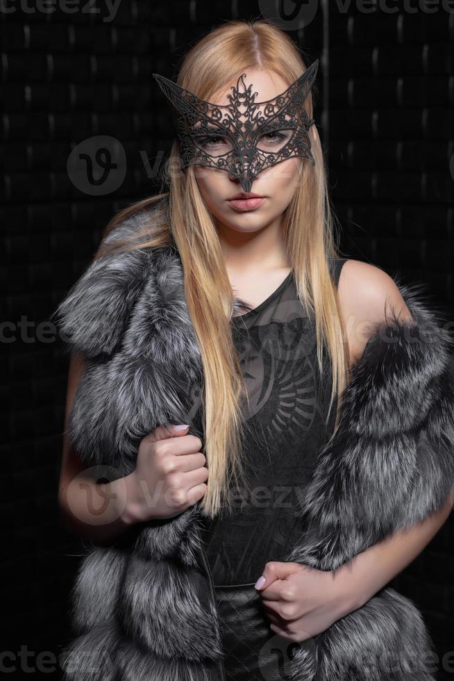 Young cute blonde in a mask photo