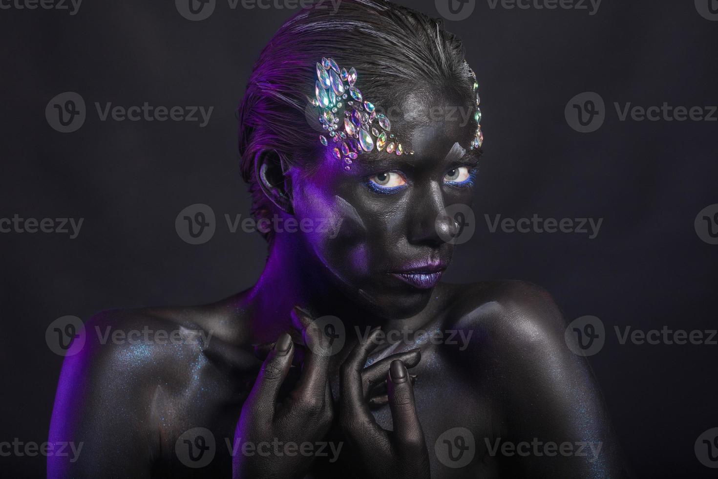 Cute brunette with creative makeup on face photo