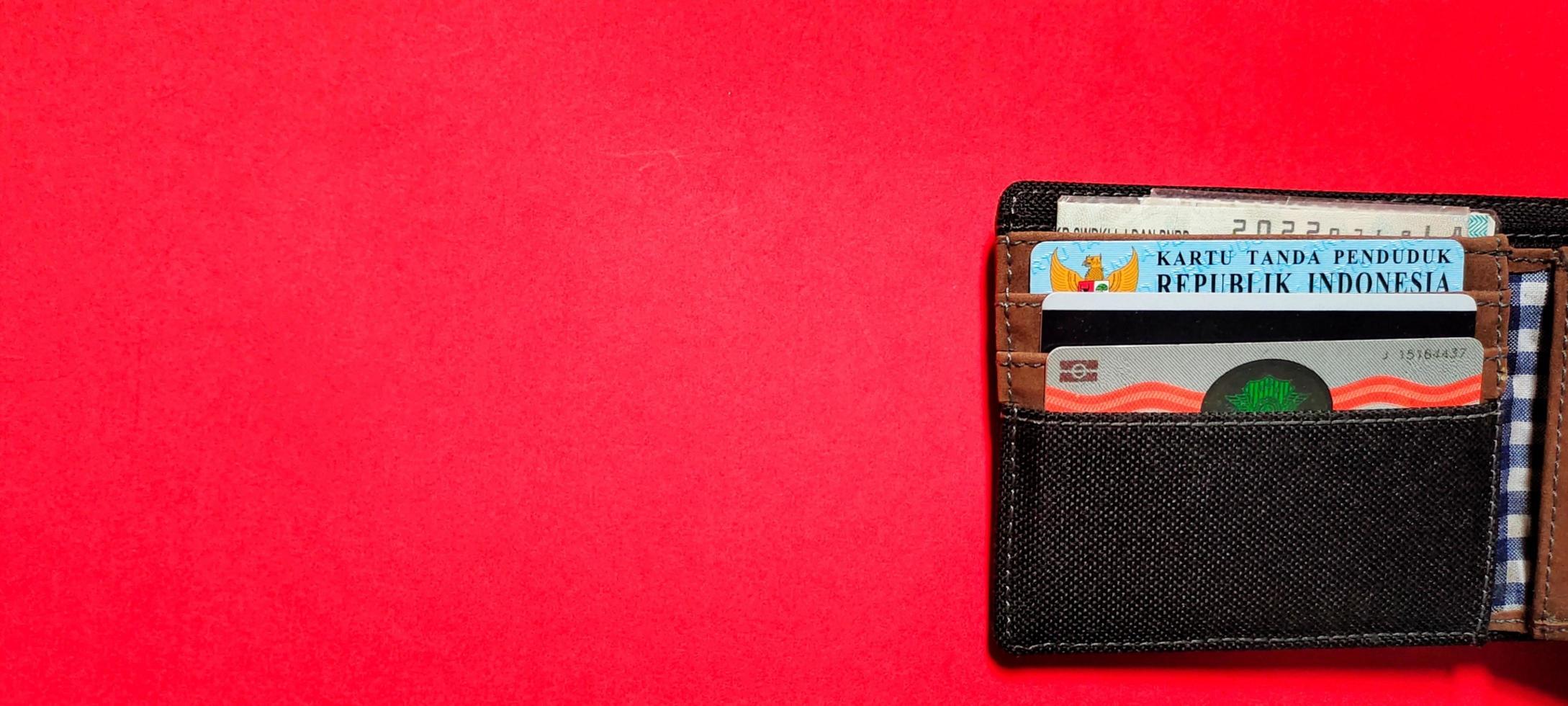 Black wallet containing driving card, residence card and motor vehicle certificate, Negative space. photo