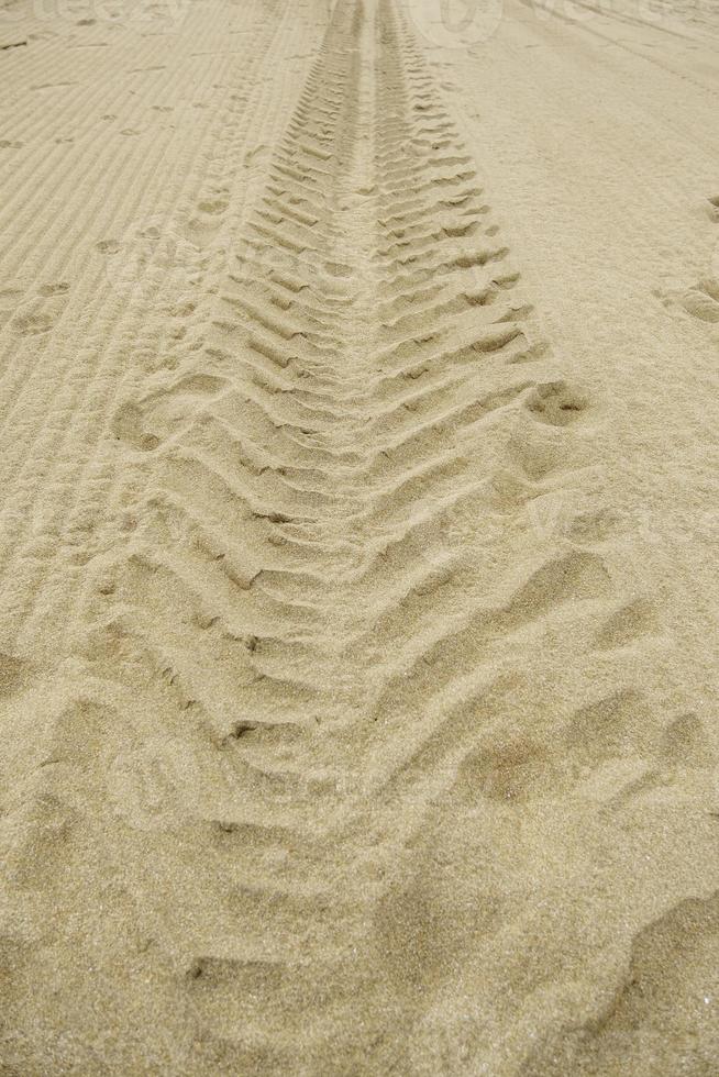 Wheel tracks on the beach photo