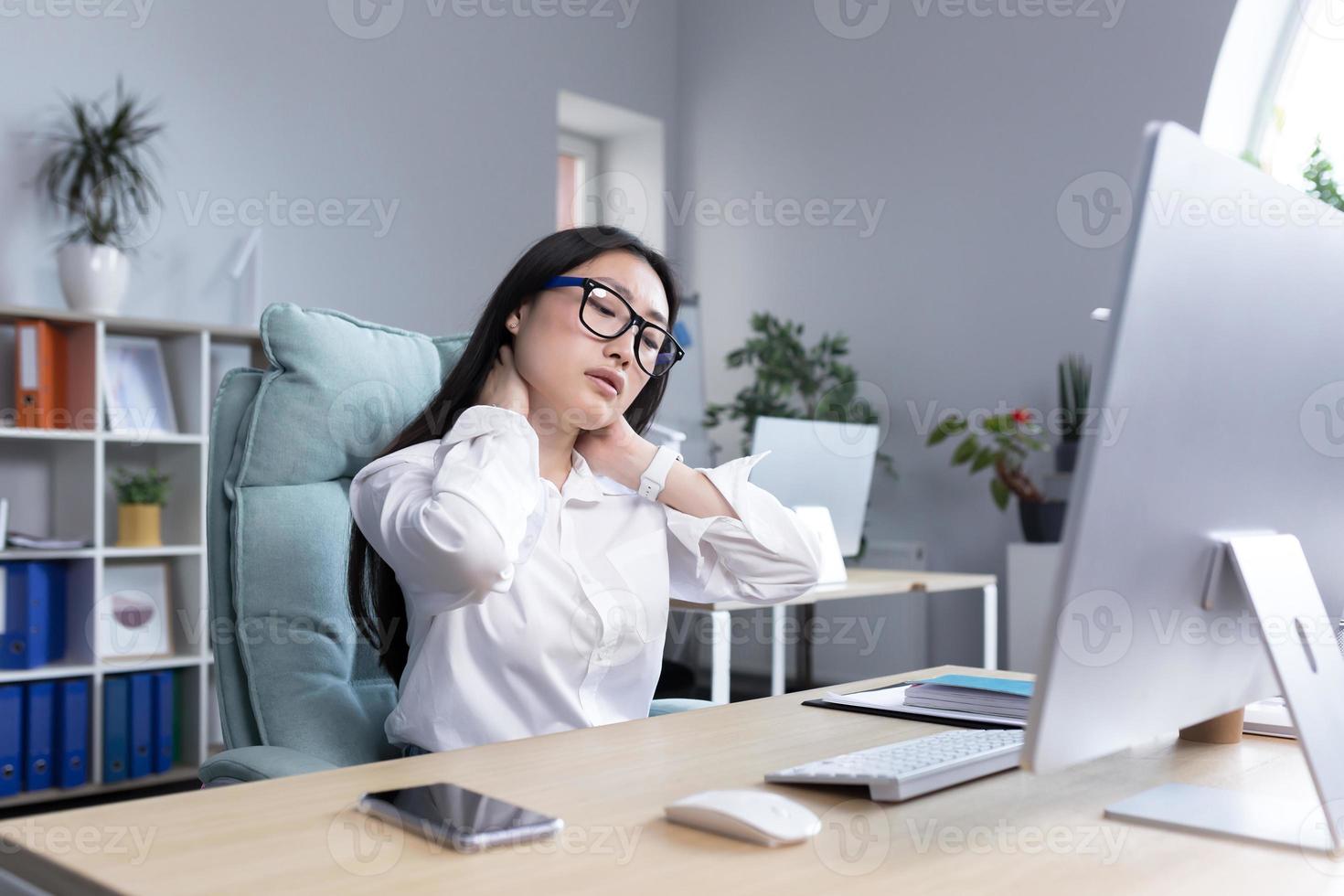 Young beautiful Asian woman business woman doing neck massage with two hands, taking a break photo