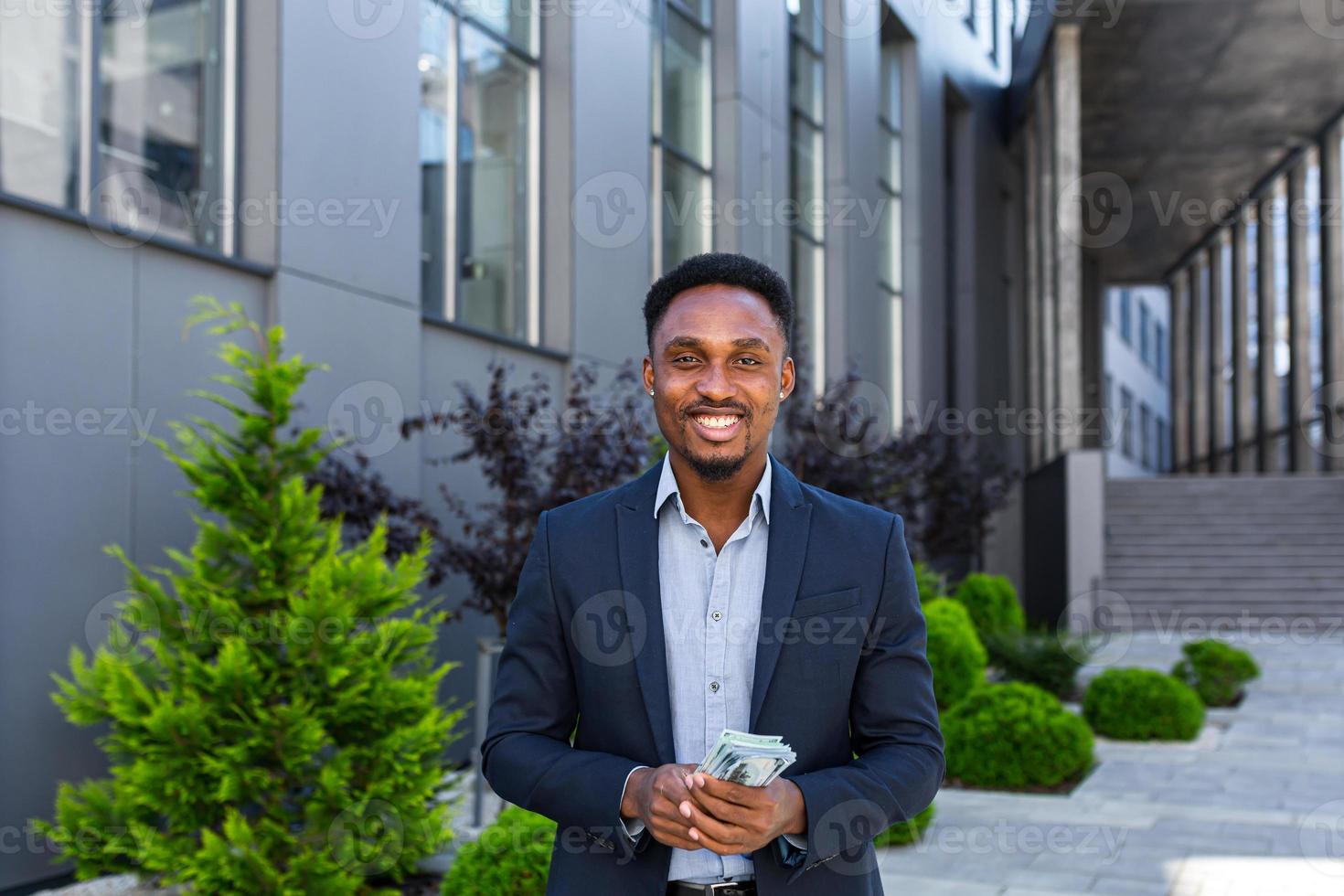 Happy successful African American businessman counts, waves, throws, show off photo