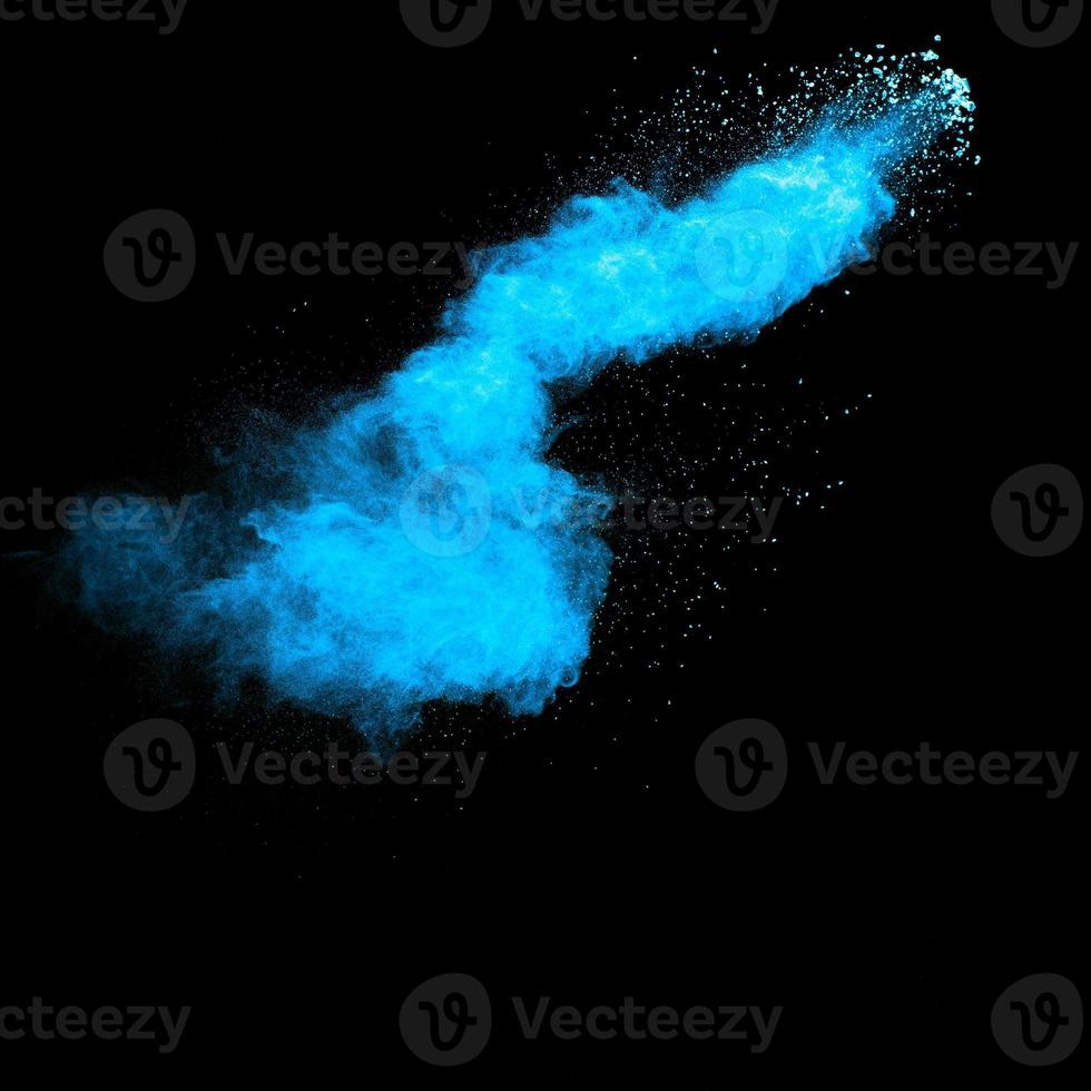 Blue color dust particles explosion cloud on black background.Color powder splash. photo