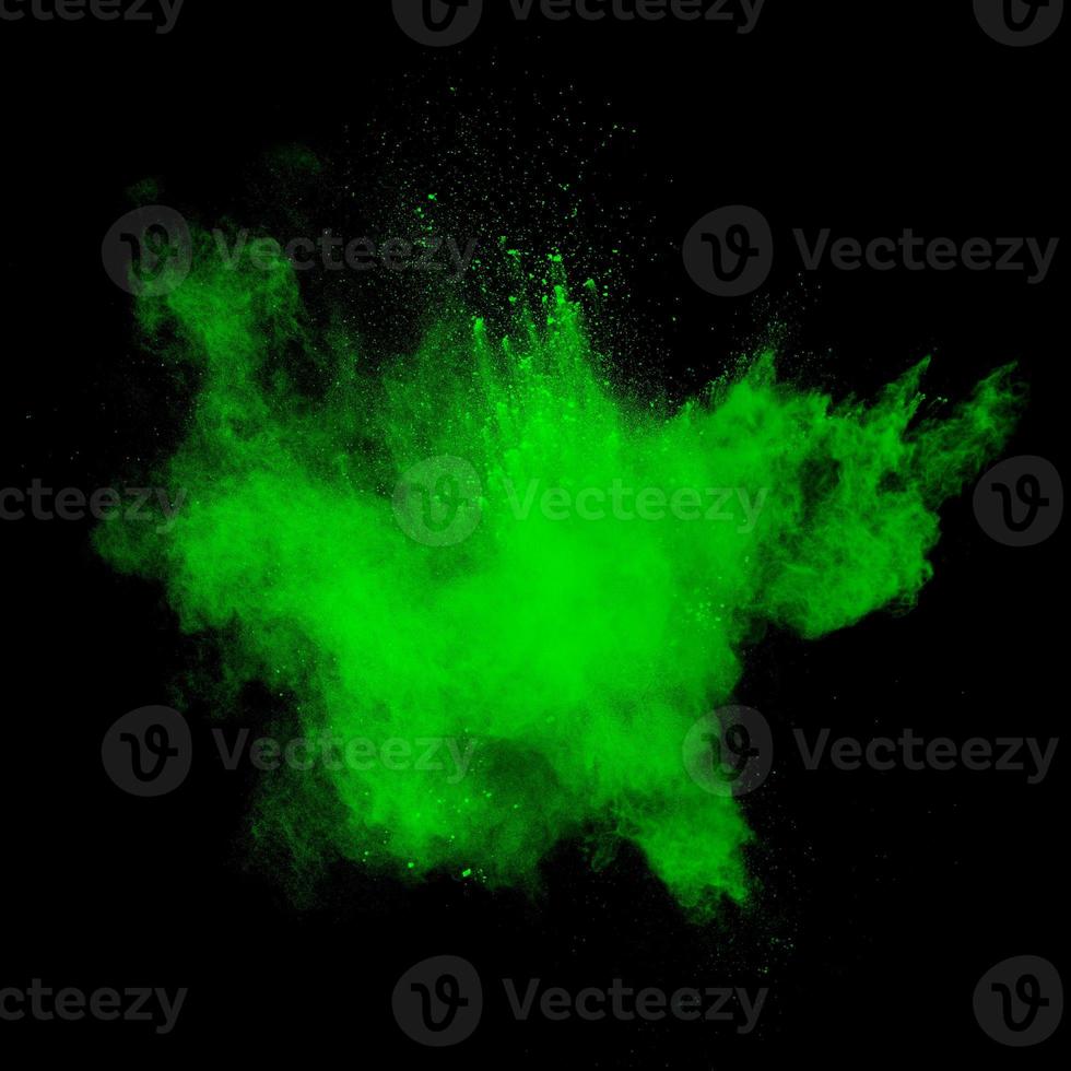 Green dust explosion on black background. Colored powder splatter on background. photo