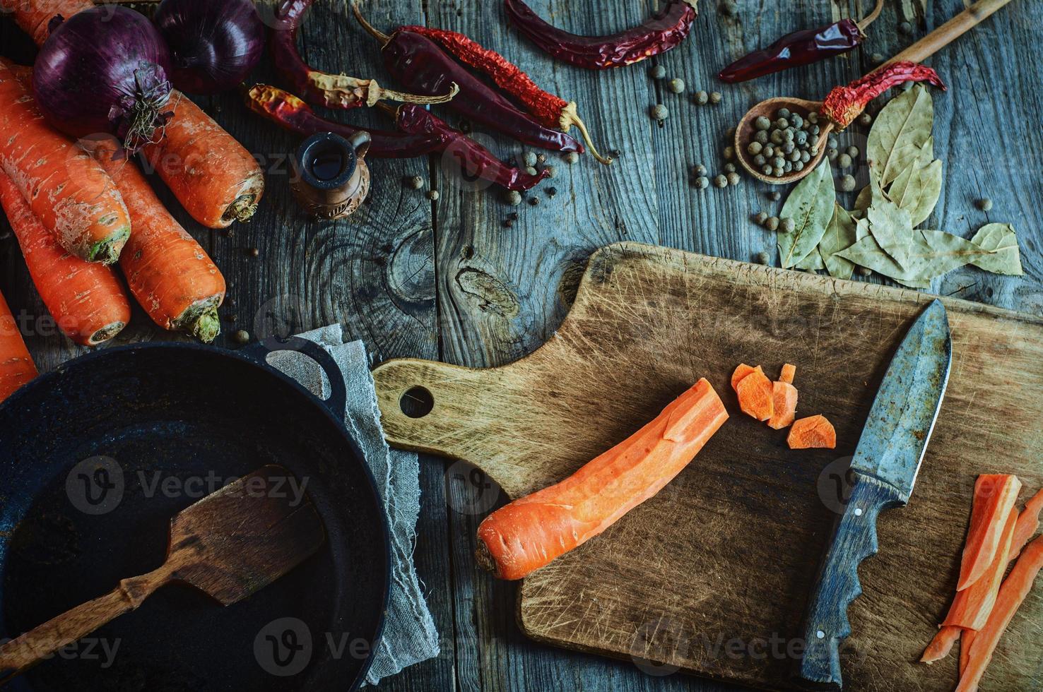 Fresh vegetables, spices and black frying pan for cooking meals photo