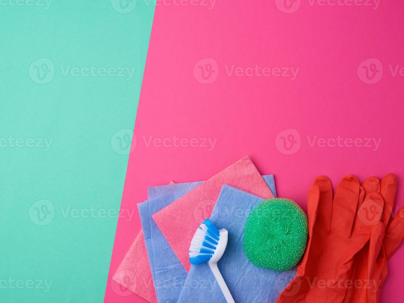 items for home cleaning red rubber gloves, brush, multi-colored sponges for dusting photo