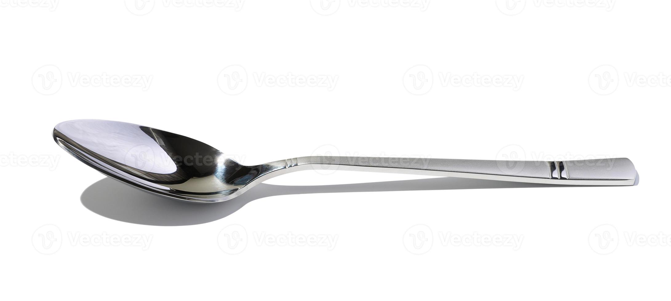 Metal spoon for soup on a white isolated background photo