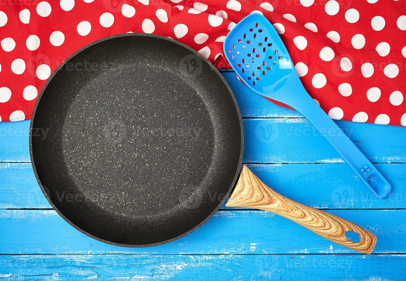 empty black round nonstick frying pan with handle photo