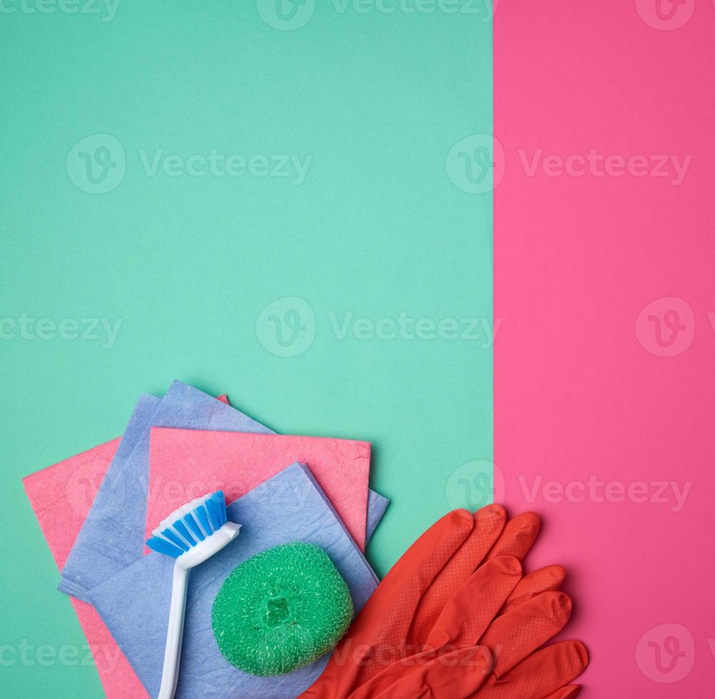 items for home cleaning red rubber gloves, brush, multi-colored sponges for dusting photo