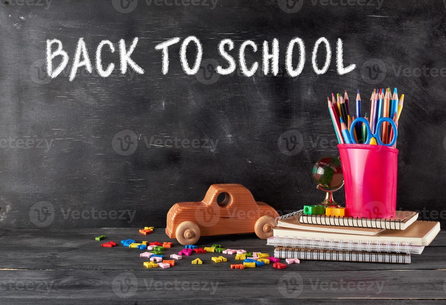 chool supplies notebook, pencils, scissors and a wooden retro toy car photo