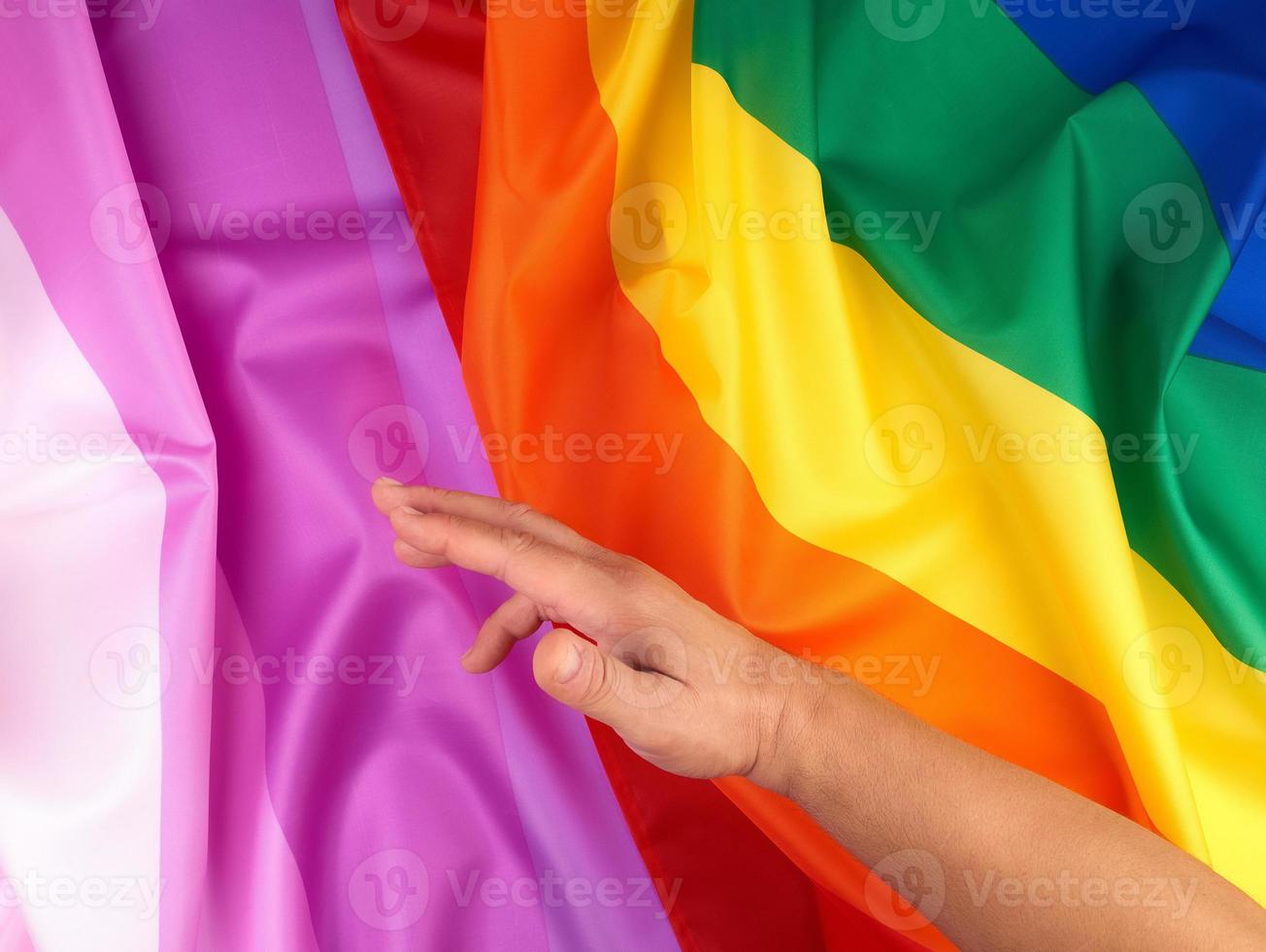 male hand and rainbow flag a symbol of the LGBT community photo