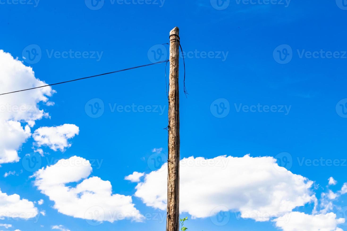 Power electric pole with line wire on colored background close up photo