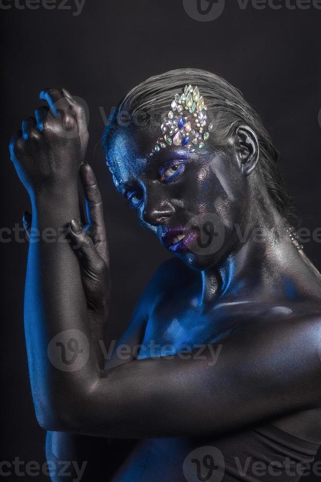 Young brunette with makeup on her face photo