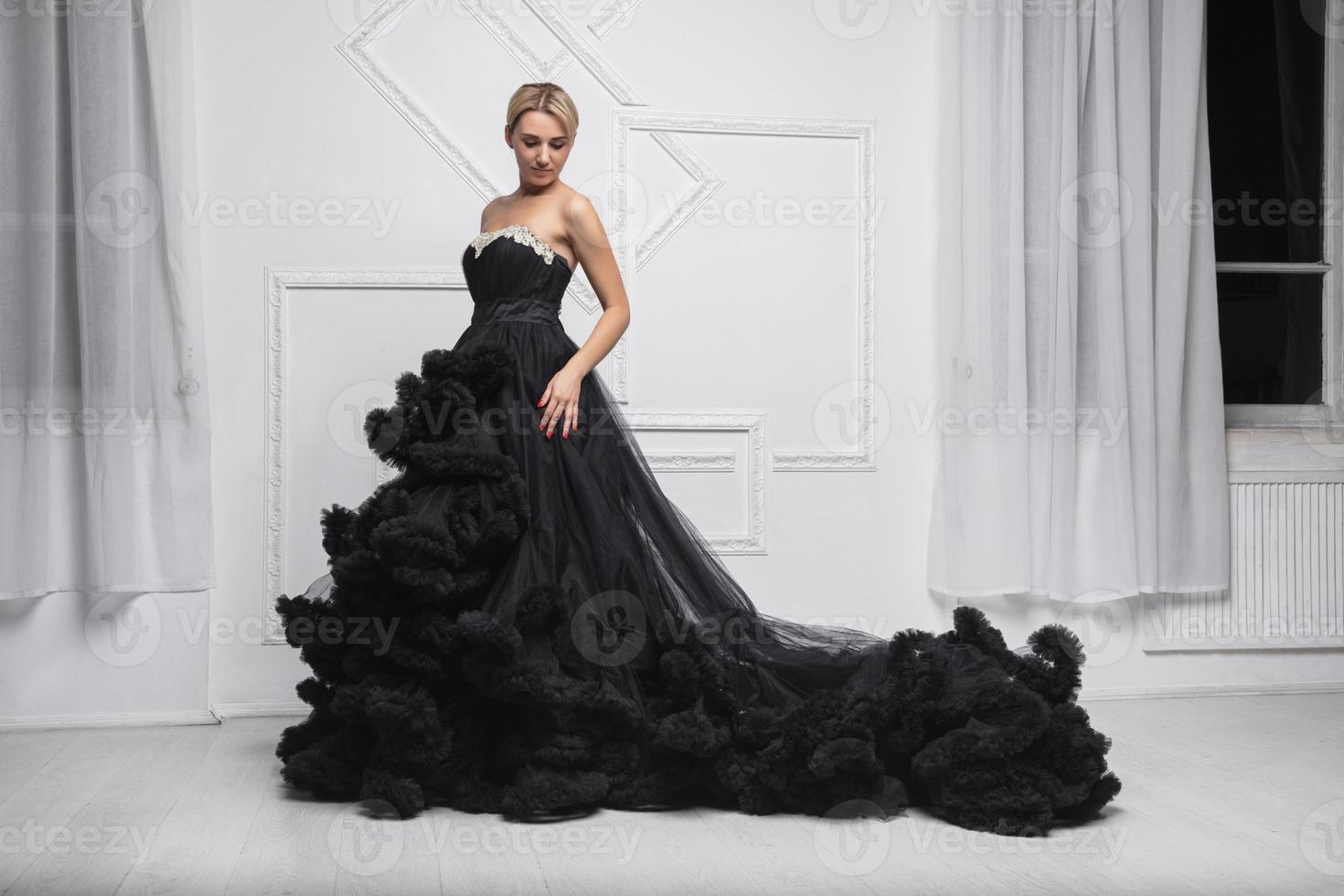Young lovely woman wearing in a magnificent evening dress photo