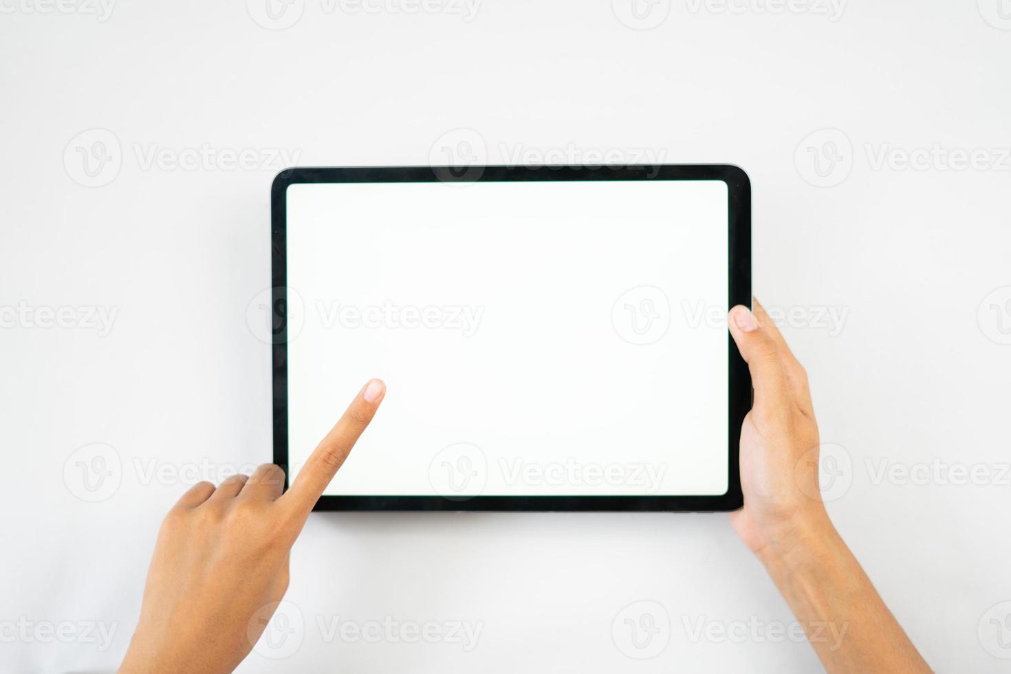 Two hands holding the tablet with a blank screen photo