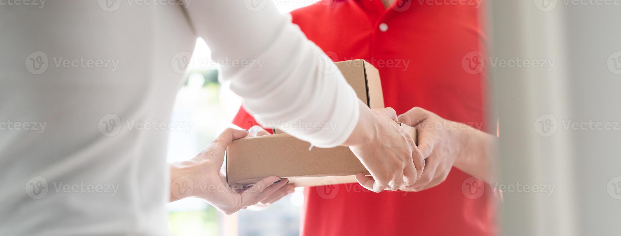 Delivery Man sending package to receiver on doorway. photo