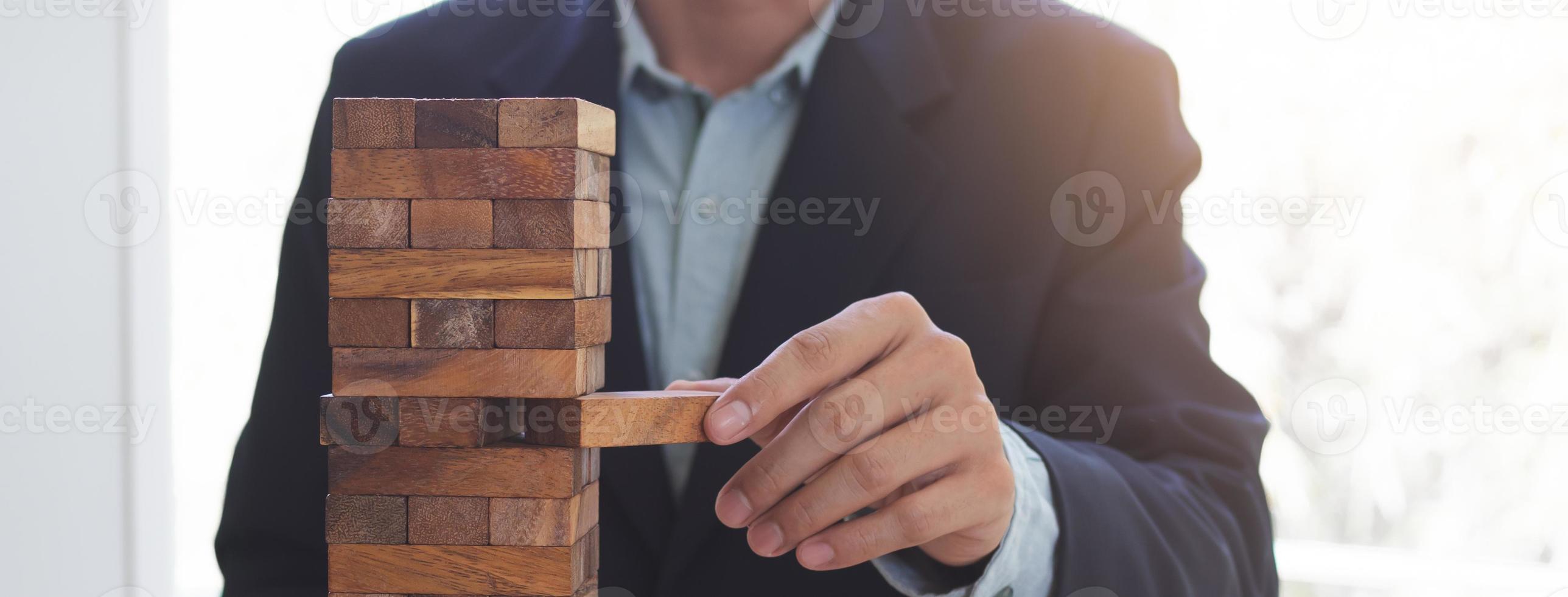 Business failure concept. businessman built block tower photo