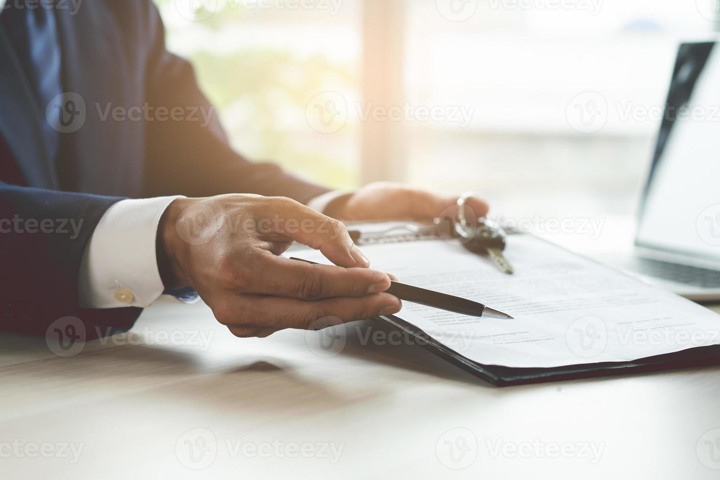 close up shots hands of client signing car lease form. photo
