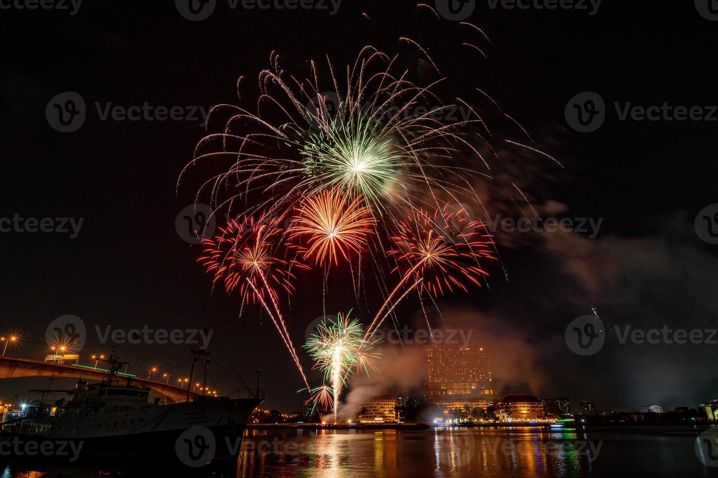 fireworks on the river in the dark sky photo