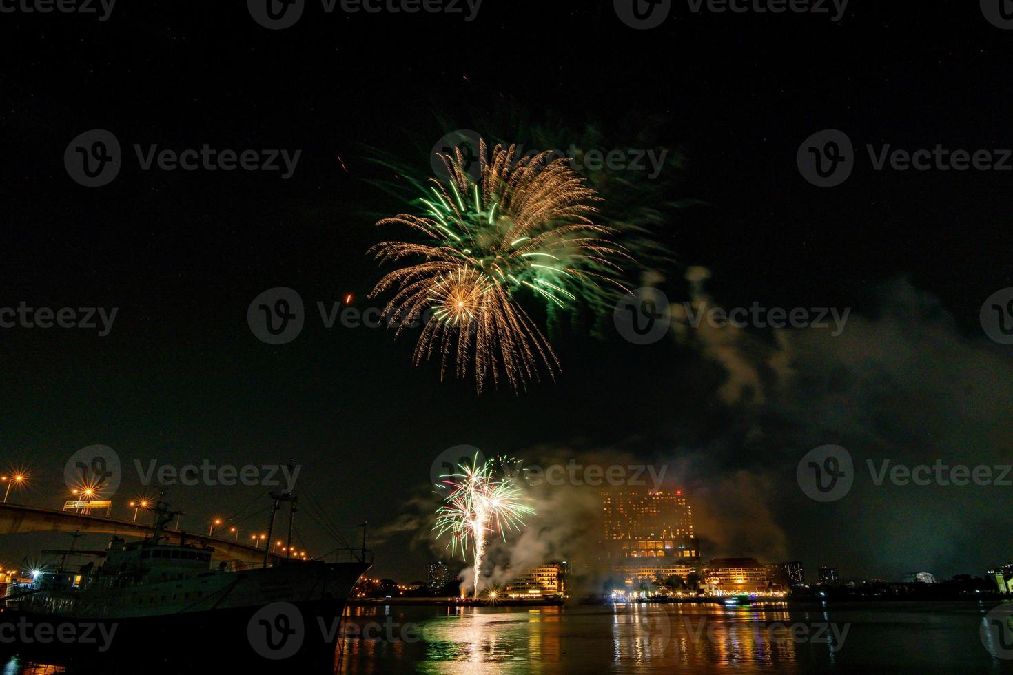 fireworks on the river in the dark sky photo